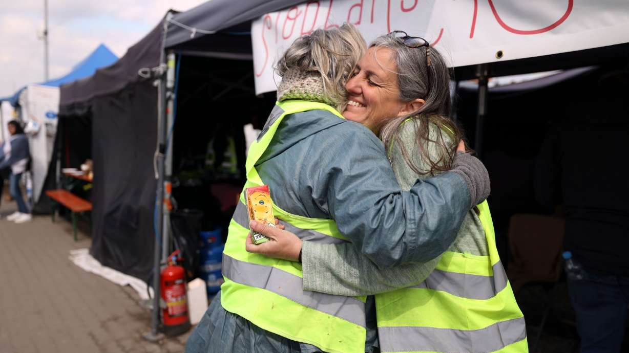 Louise Martin, left, hugs Jennifer De Tapia, of Salt Lake City, as they both volunteer for the Siobhan’s Trust tent in Medyka, Poland, on Wednesday, April 20.