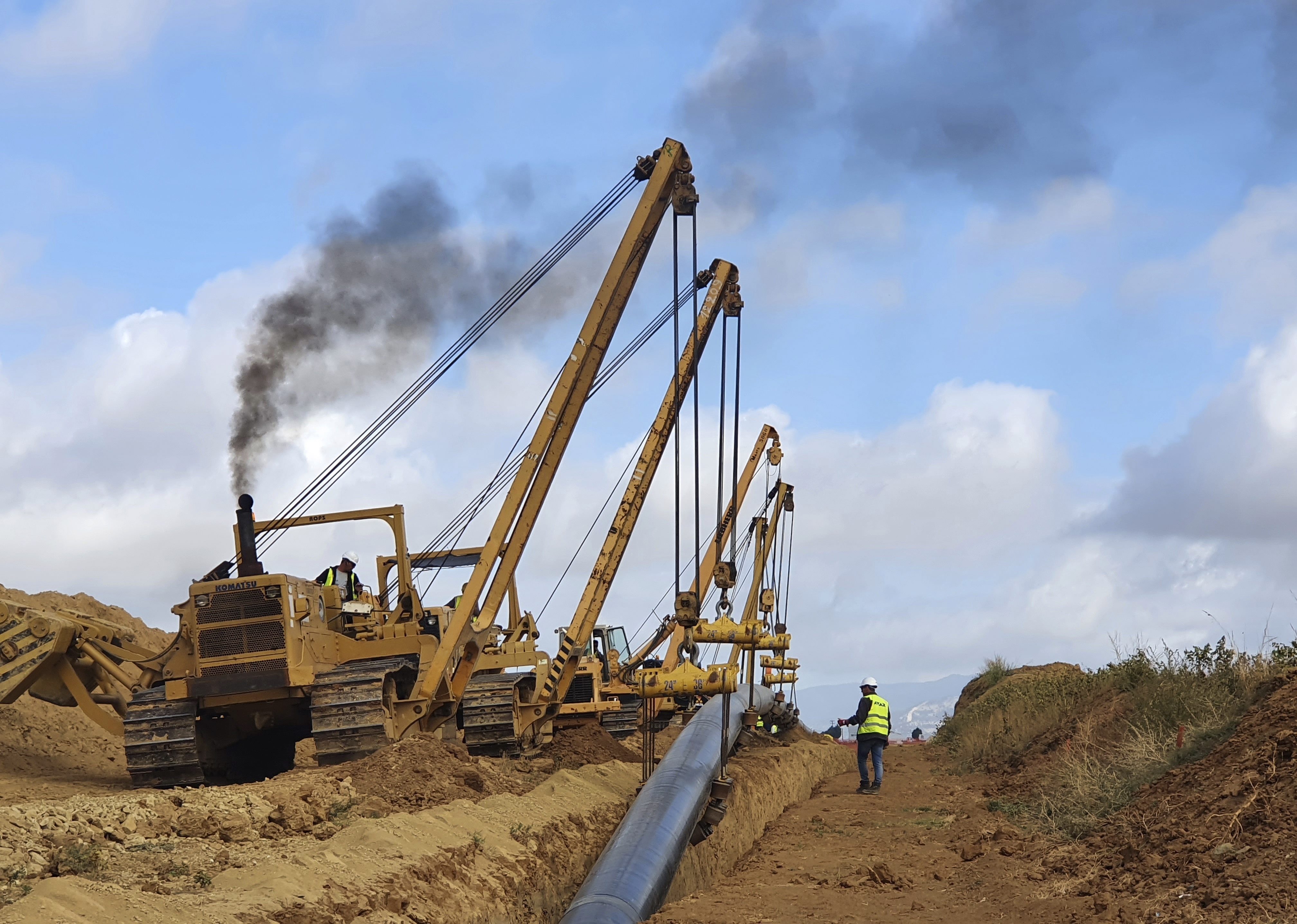 Heavy machines install a pipeline near Komotini town, northern Greece, Sept. 29, 2020. Crossing a remote border area of Greece and Bulgaria, a new pipeline nearing completion will help countries in the region dependent on Russian imports get greater access to the global natural gas market. 