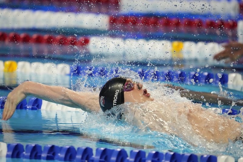 FILE PHOTO: Jun 15, 2021; Omaha, Nebraska, USA; Hunter Armstrong swims in the MenÕs 100m Backstroke Finals during the U.S. Olympic Team Trials Swimming competition at CHI Health Center Omaha.