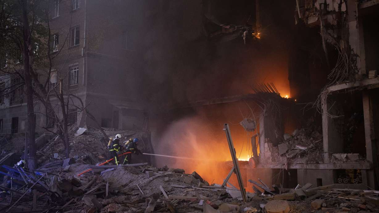 Firefighters try to put out a fire following an explosion in Kyiv, Ukraine, on Thursday. A 22-year-old former U.S. Marine was killed alongside Ukrainian forces in the war with Russia, his relatives told news outlets in what’s the first known death of an American citizen fighting in Ukraine.