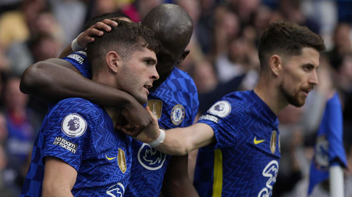 Chelsea's Christian Pulisic, left, celebrates with teammates after scoring the only goal of the game during the English Premier League soccer match between Chelsea and West Ham United at Stamford Bridge in London, Sunday, April 24, 2022. Chelsea won the match 1-0.