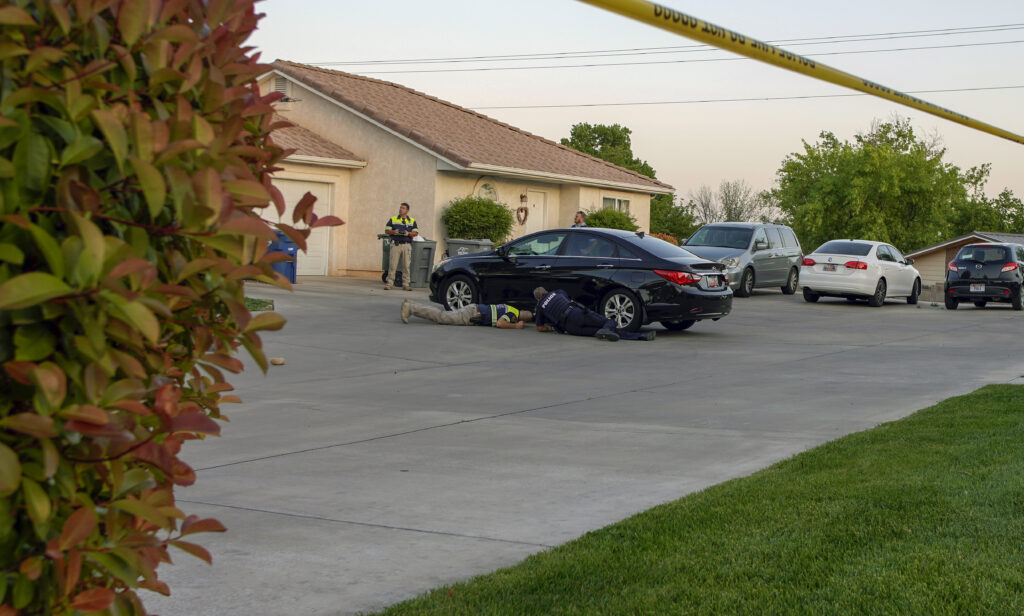 St. George Police Department's accident reconstruction team investigates the scene after a 9-year-old was run over in the driveway of a home on 610 North in St. George, Thursday.
