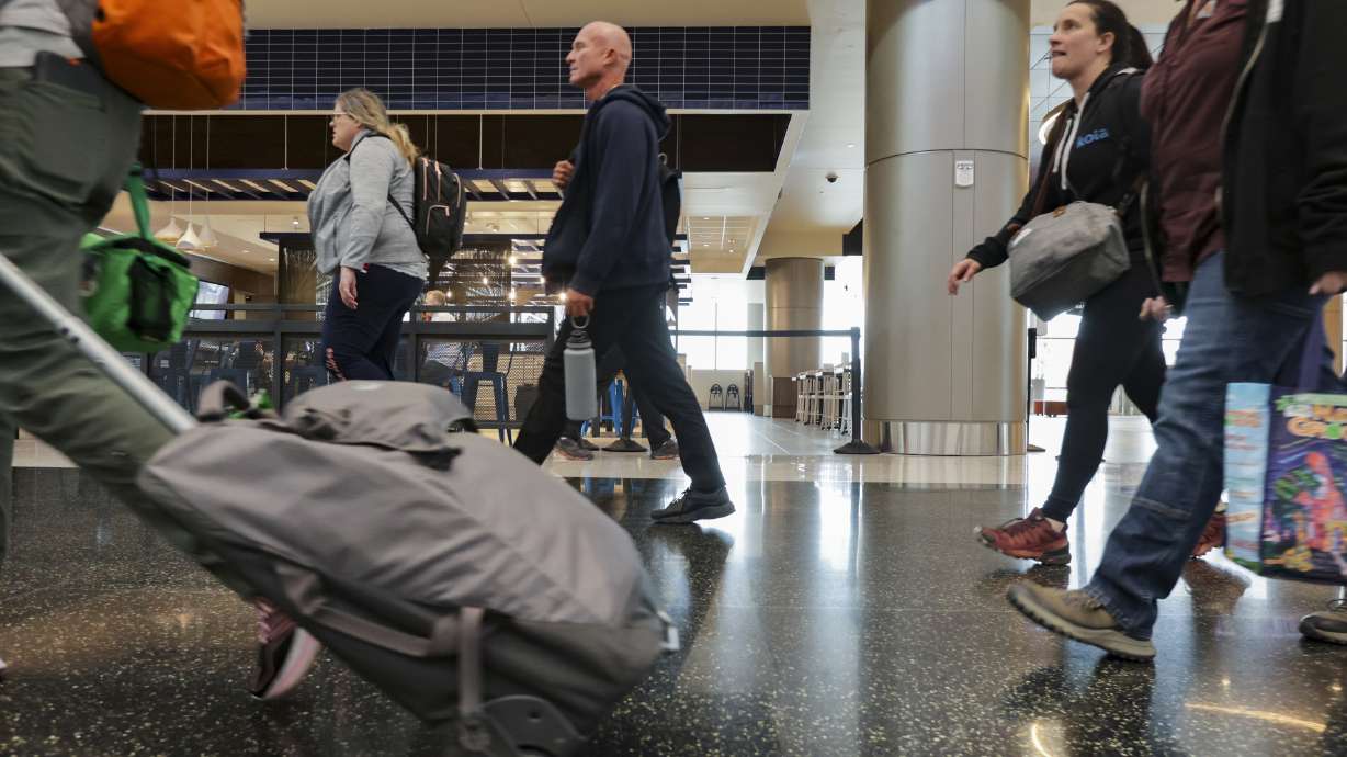Travelers walk through the Salt Lake City International Airport in Salt Lake City on April 19. Where does the Salt Lake City airport rank among national and global airports?