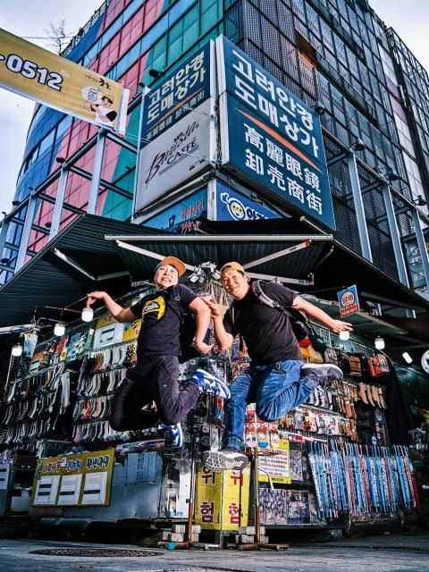 Dok Kwon, left, and Jung Song, right, jump into the air for a picture during a business trip in South Korea. Cupbop started with a single food truck, and now they'll have the chance to show America the food that turned their business from one truck to a company with over 100 locations across the globe.