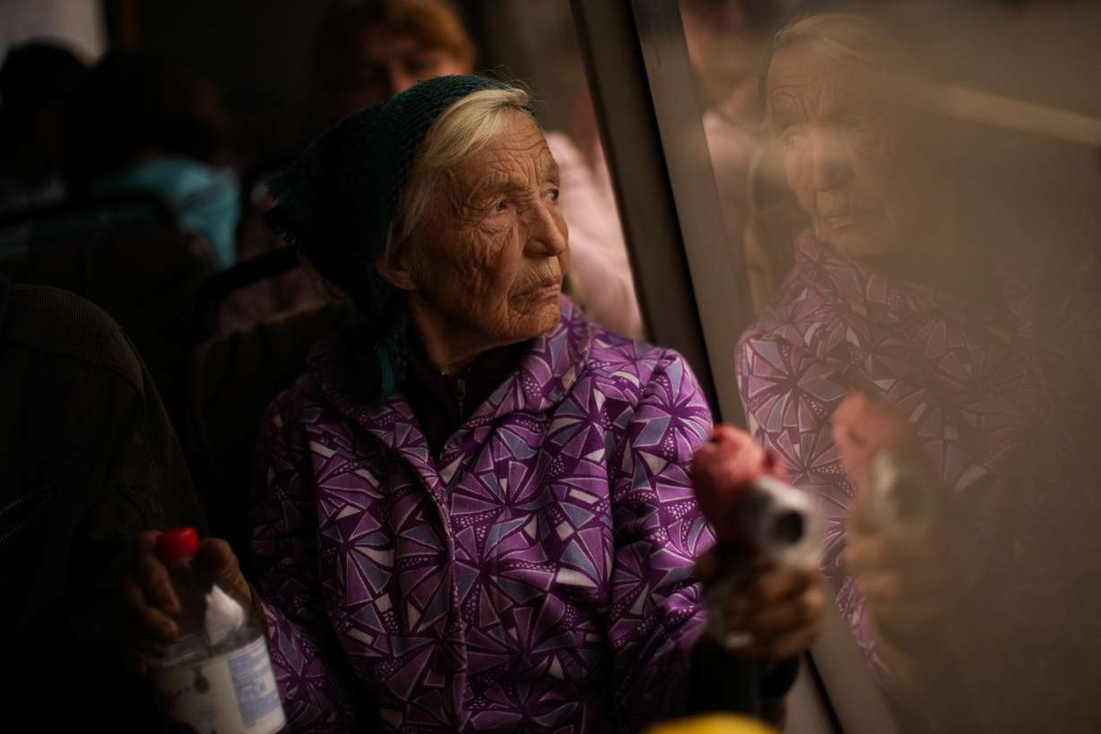 Kateryna Hodza, 85, takes a bus from a reception center for displaced people in Zaporizhzhia, Ukraine, Friday. They fled from Mala Tokmachka, in Zaporizhzhia region, as thousands of Ukrainian continue to leave Russian occupied areas.