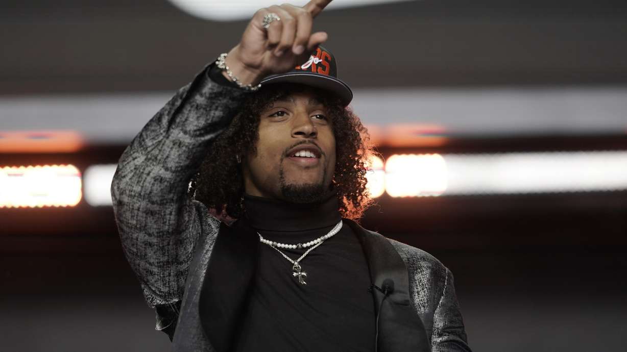 Washington cornerback Kyler Gordon points after being selected by the Chicago Bears during the second round of the NFL football draft Friday, April 29, 2022, in Las Vegas.