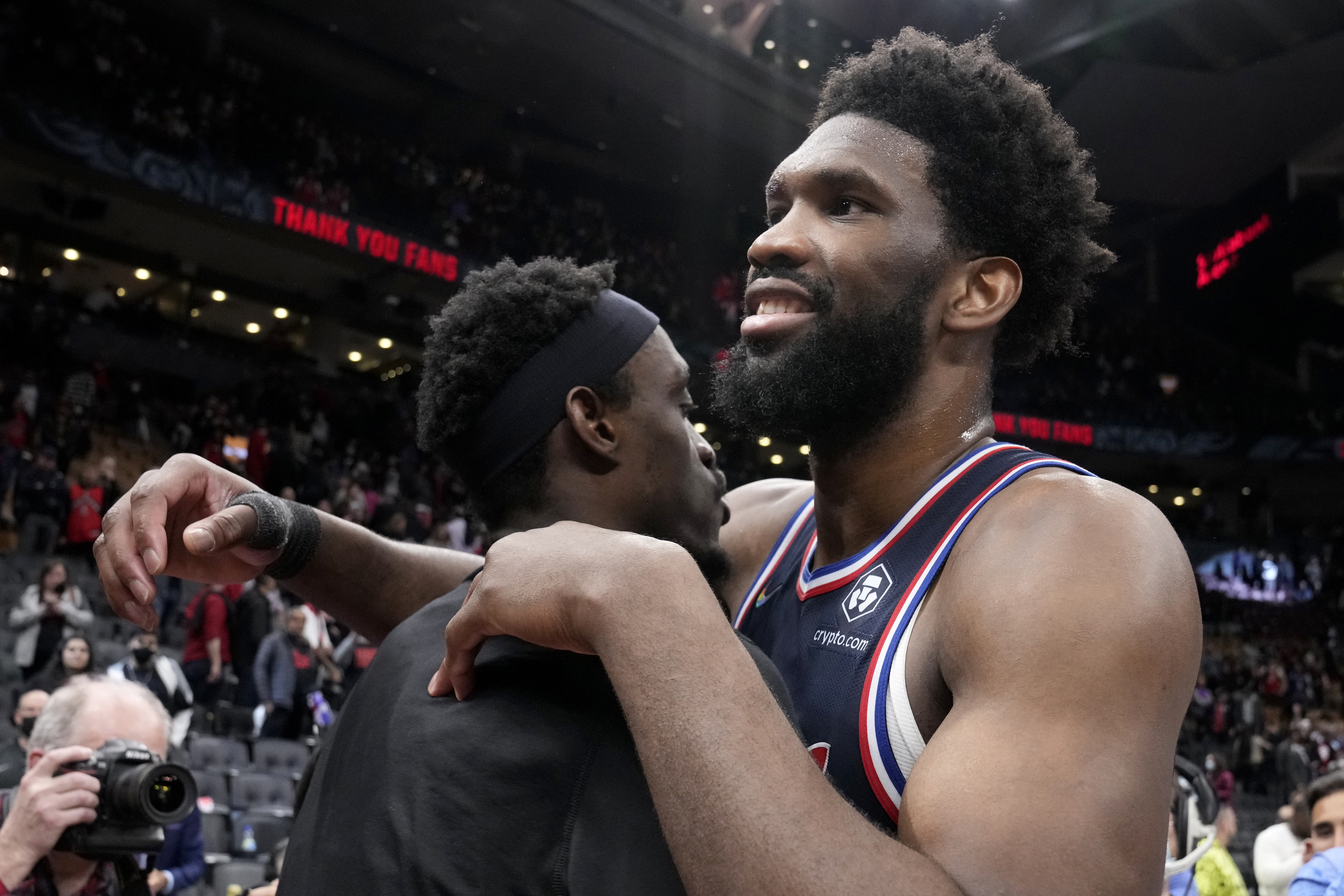 Toronto Raptors forward Pascal Siakam, left, and Philadelphia 76ers center Joel Embiid, right, embrace after Game 6 of an NBA basketball first-round playoff series in Toronto, Thursday, April 28, 2022. 