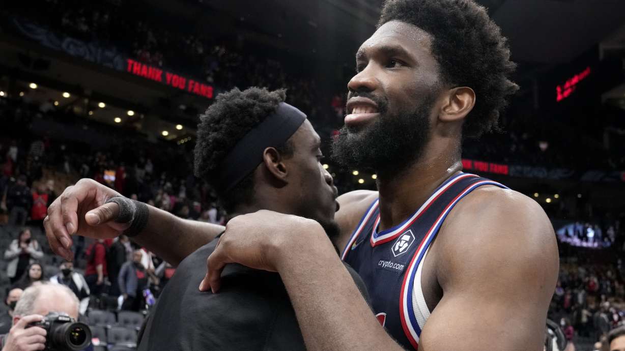 Toronto Raptors forward Pascal Siakam, left, and Philadelphia 76ers center Joel Embiid, right, embrace after Game 6 of an NBA basketball first-round playoff series in Toronto, Thursday, April 28, 2022.