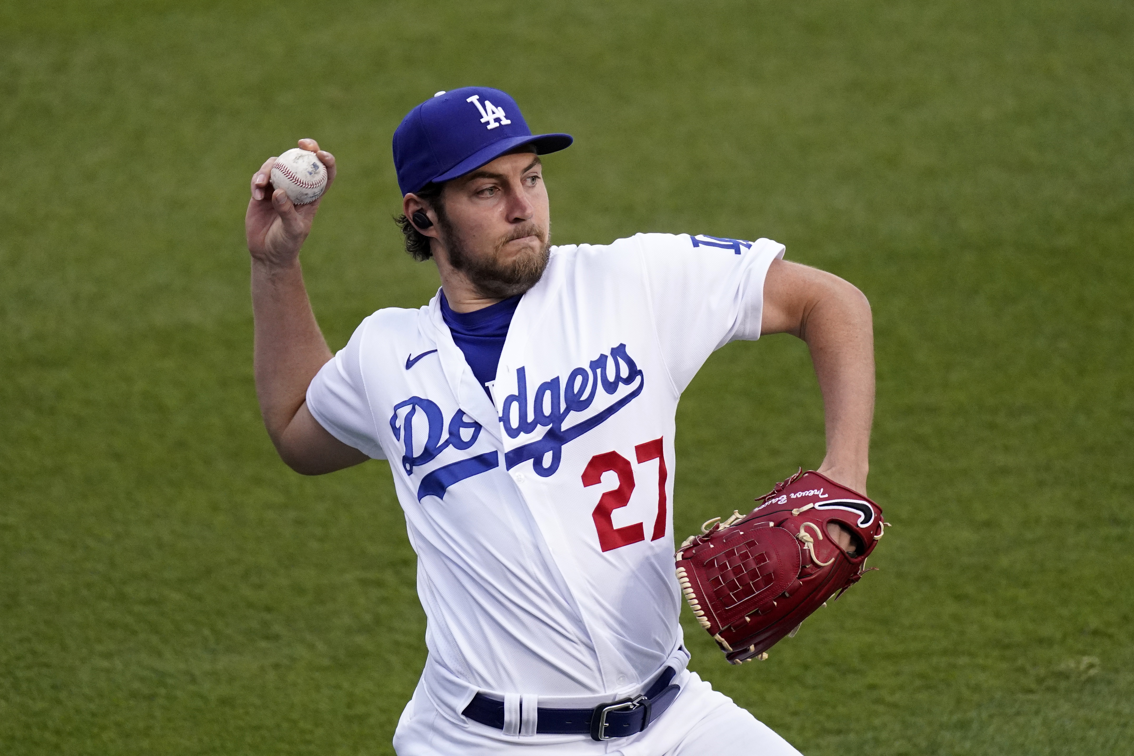FILE - Los Angeles Dodgers starting pitcher Trevor Bauer warms up prior to a baseball game against the Colorado Rockies, April 13, 2021, in Los Angeles. Bauer was suspended Friday, April 29, 2022, for two full seasons without pay by Major League Baseball for violating the league's domestic violence and sexual assault policy, which he denies. 