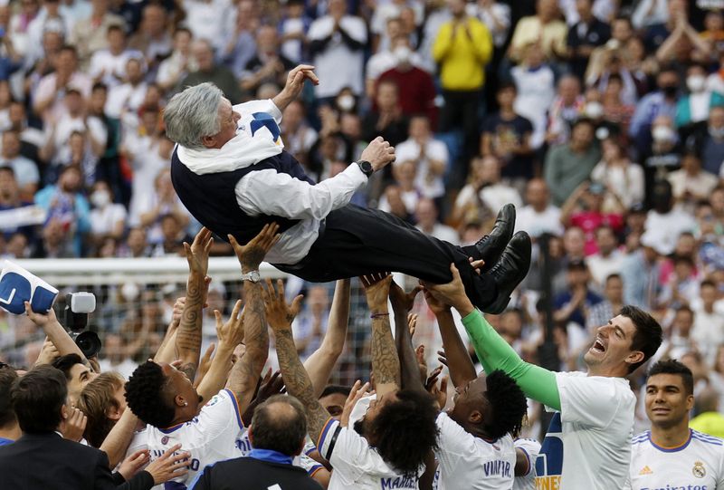 Soccer Football - LaLiga - Real Madrid v Espanyol - Santiago Bernabeu, Madrid, Spain - April 30, 2022 Real Madrid team members lift coach Carlo Ancelotti in the air and celebrate after winning LaLiga