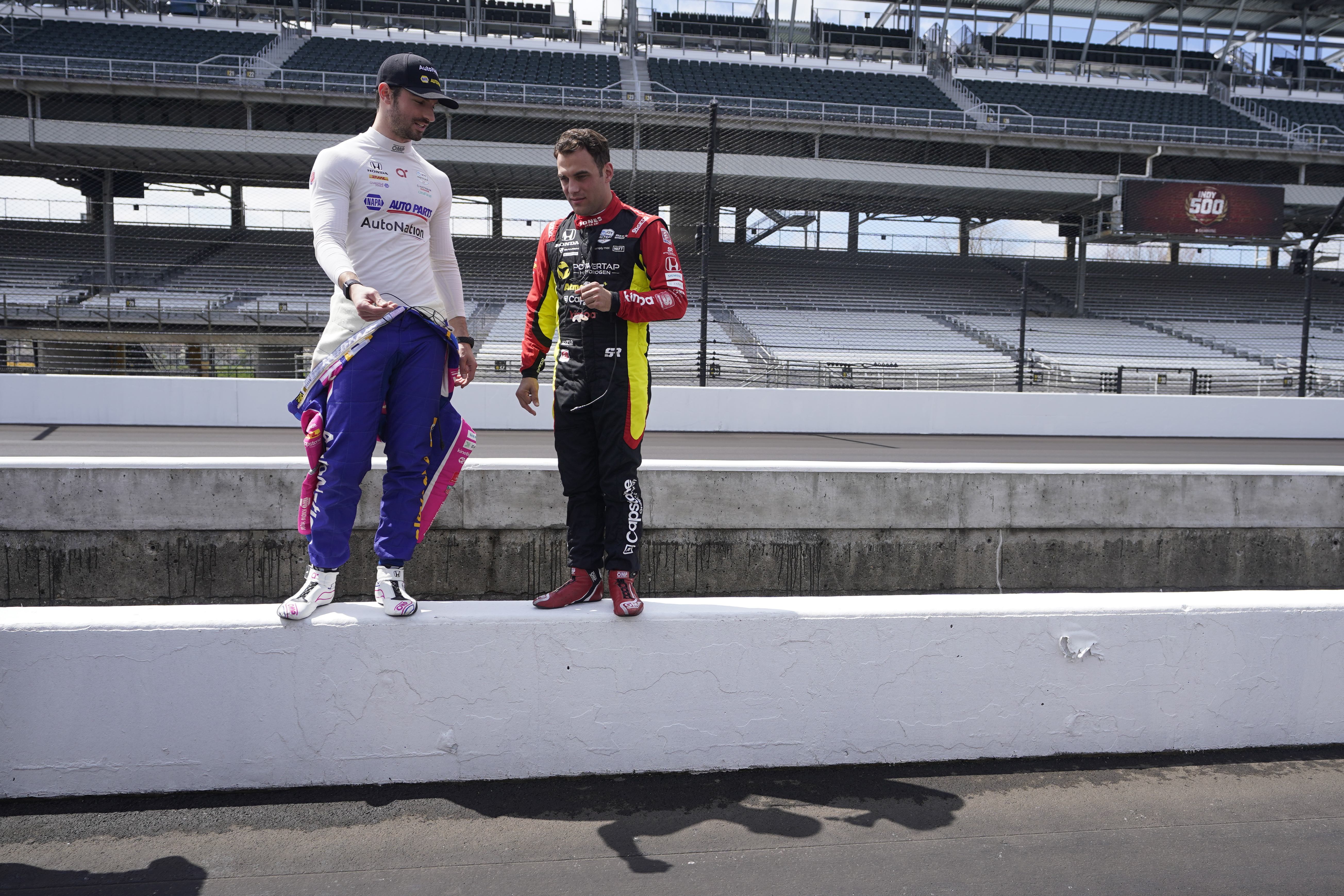 Alexander Rossi, left, and Delvin Defrancesco look at pit lane before testing at Indianapolis Motor Speedway, Thursday, April 21, 2022, in Indianapolis. 