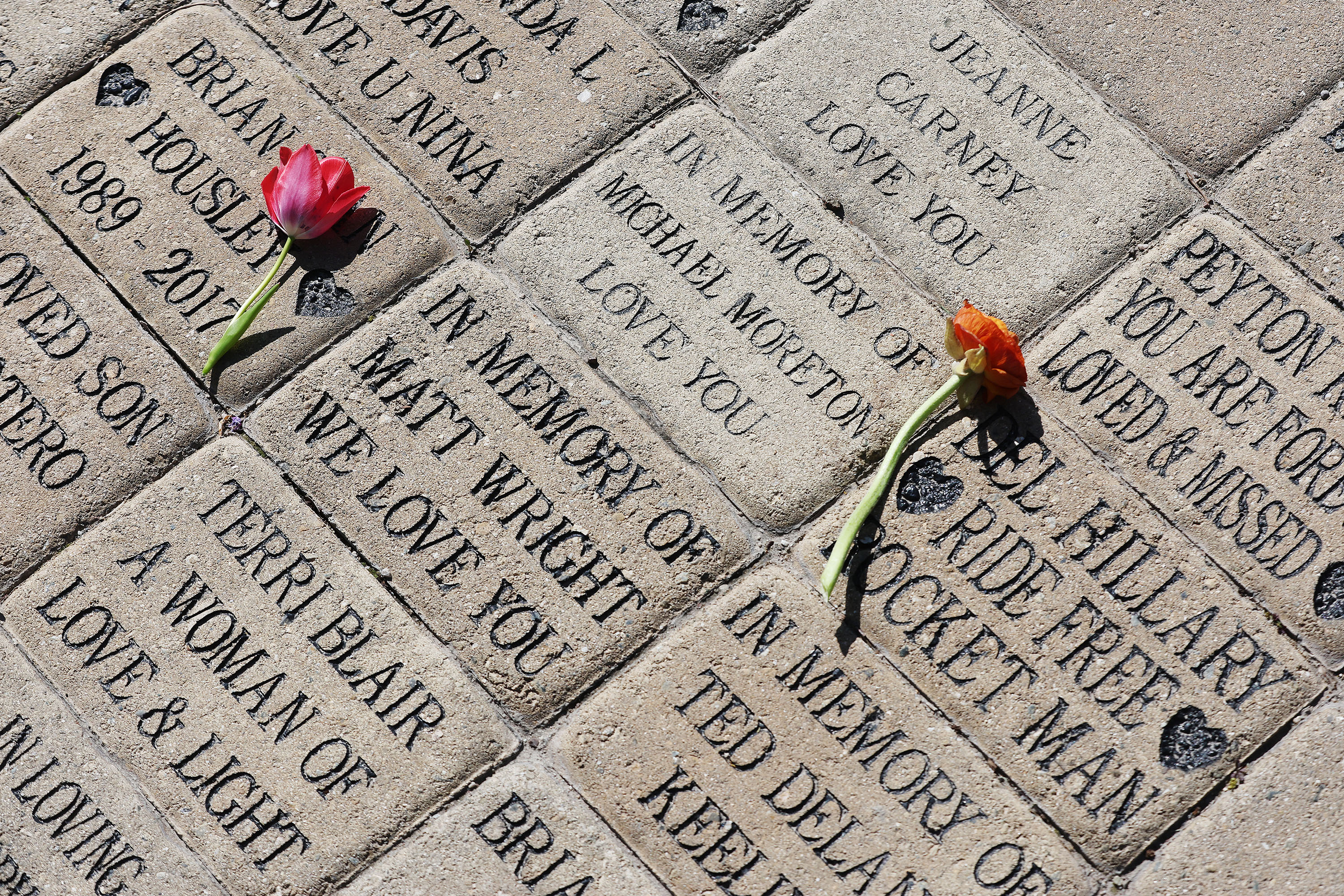 Flowers are left on donor bricks during National Donate Life Month and Donor Remembrance Day at the Celebration of Life Monument in Salt Lake City on Saturday.