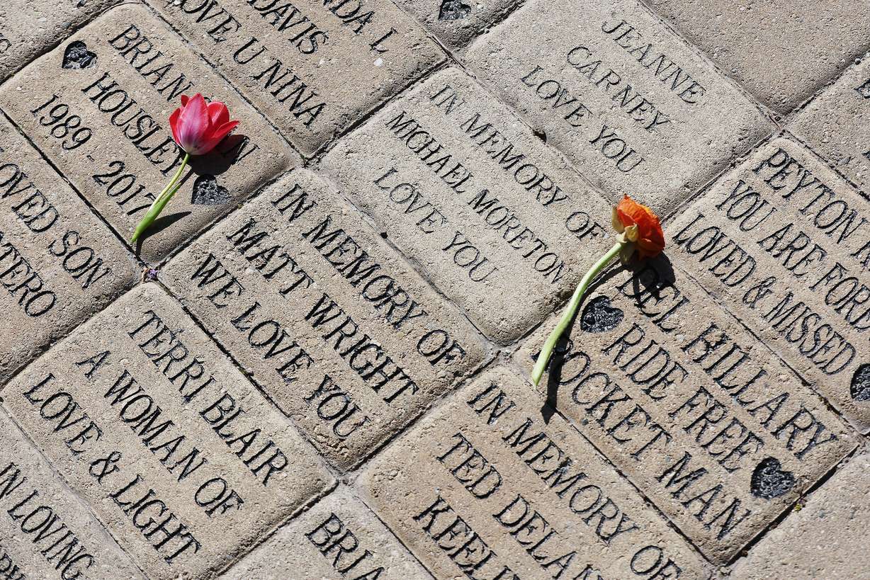 Flowers are left on donor bricks during National Donate Life Month and Donor Remembrance Day at the Celebration of Life Monument in Salt Lake City on Saturday.