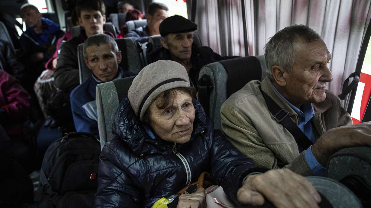 People sit in a bus during evacuation from Lyman, Donetsk region, eastern Ukraine, Saturday.