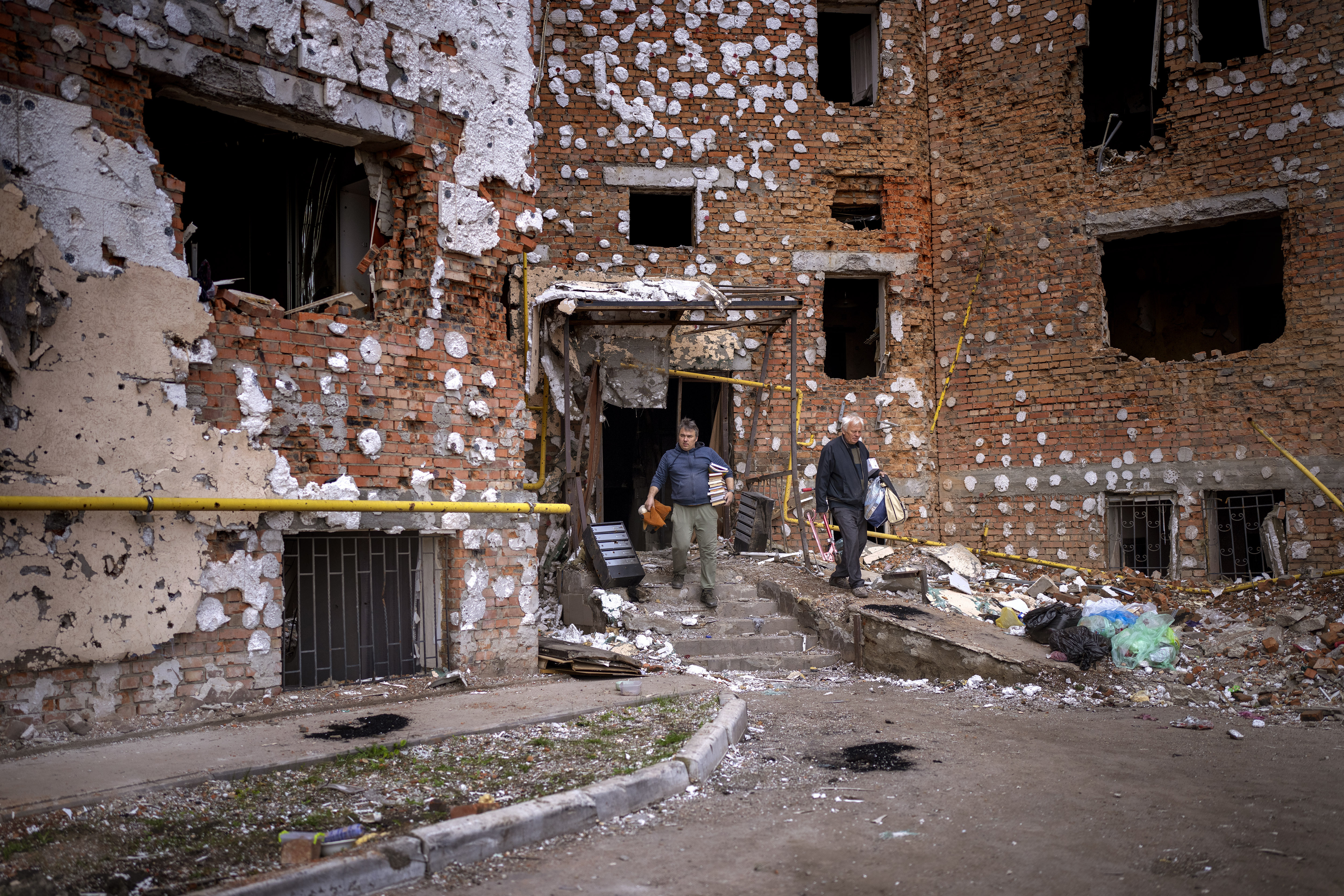 Oleksiy Onoschenko, 42, rescues books from his house destroyed during the Russian occupation in Irpin, on the outskirt of Kyiv, Ukraine, on Saturday.