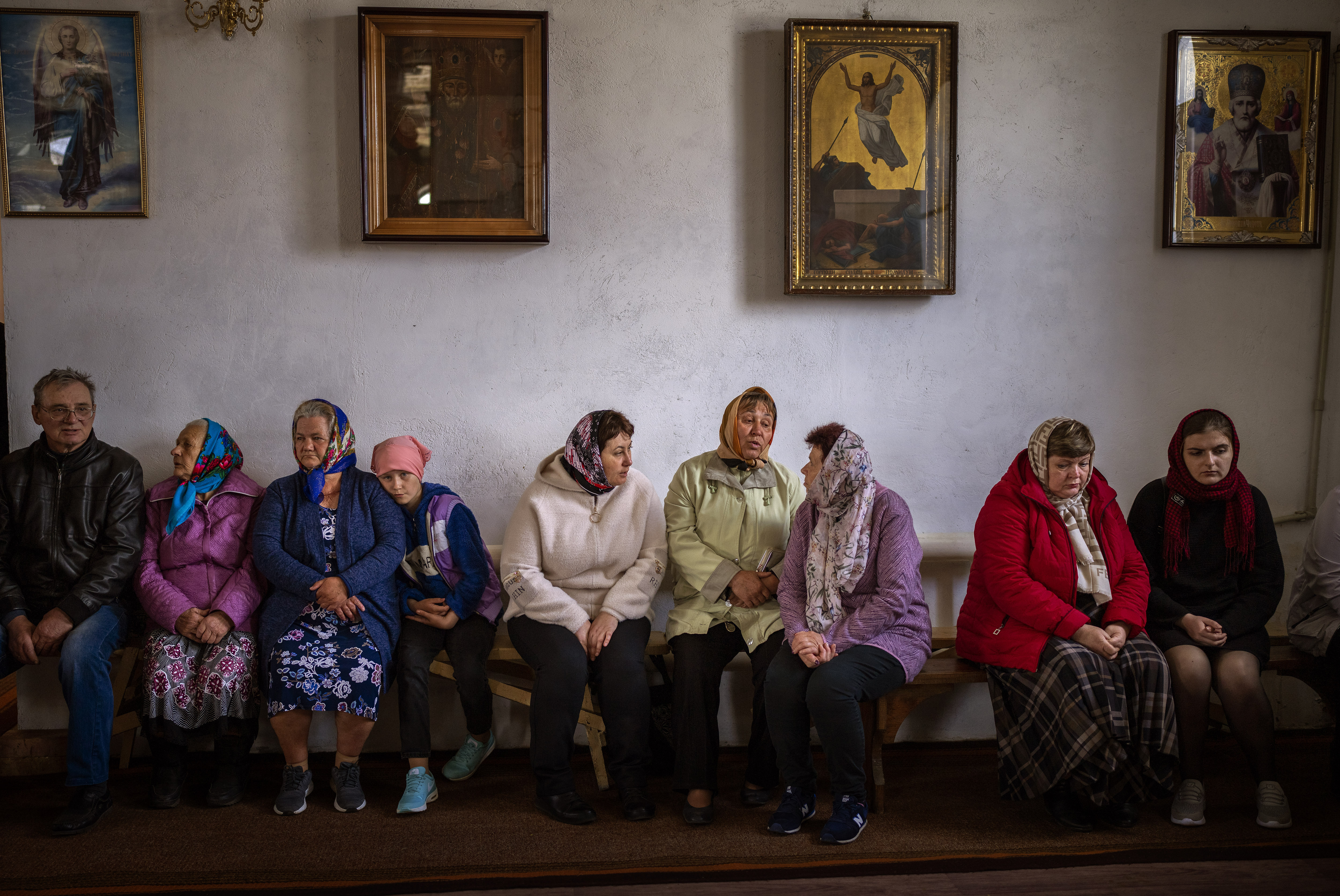 Ukraine women wait for the start of a religious service to commemorate the fallen during the Russian occupation in Zdvyzhivka, on the outskirts of Kyiv, on Saturday.