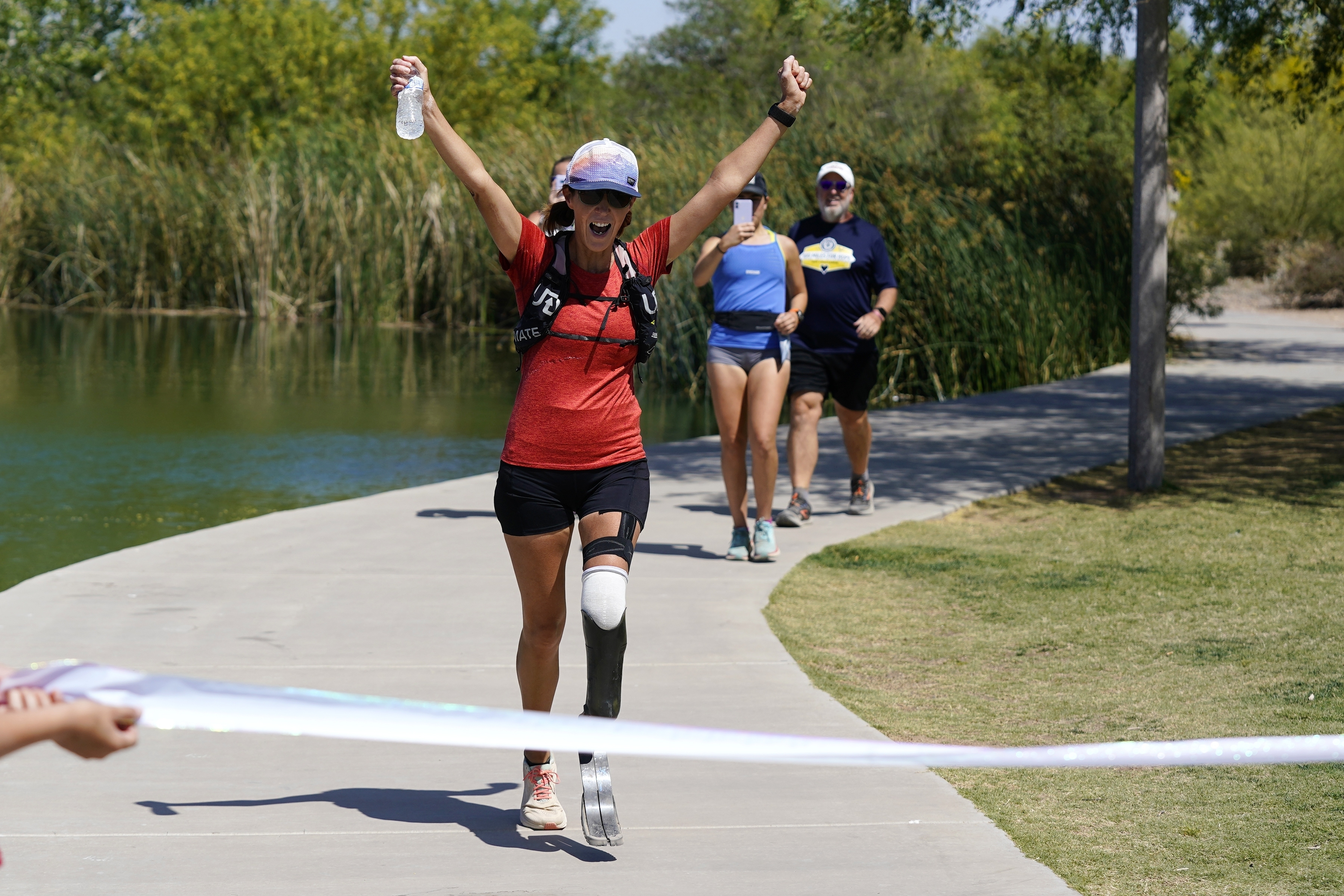 Jacky Hunt-Broersma finishes her 102nd marathon in 102 days, this one at Veterans Oasis Park, Thursday, April 28, 2022, in Chandler, Ariz. 