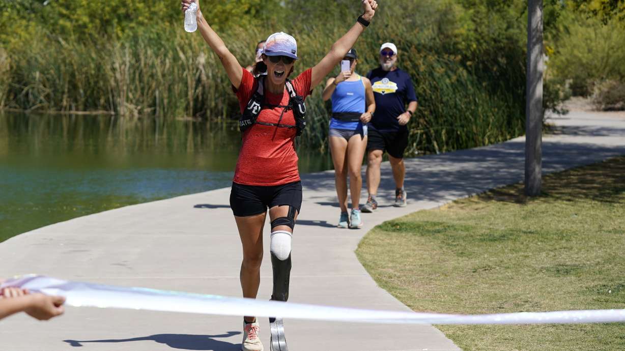Jacky Hunt-Broersma finishes her 102nd marathon in 102 days, this one at Veterans Oasis Park, Thursday, April 28, 2022, in Chandler, Ariz.
