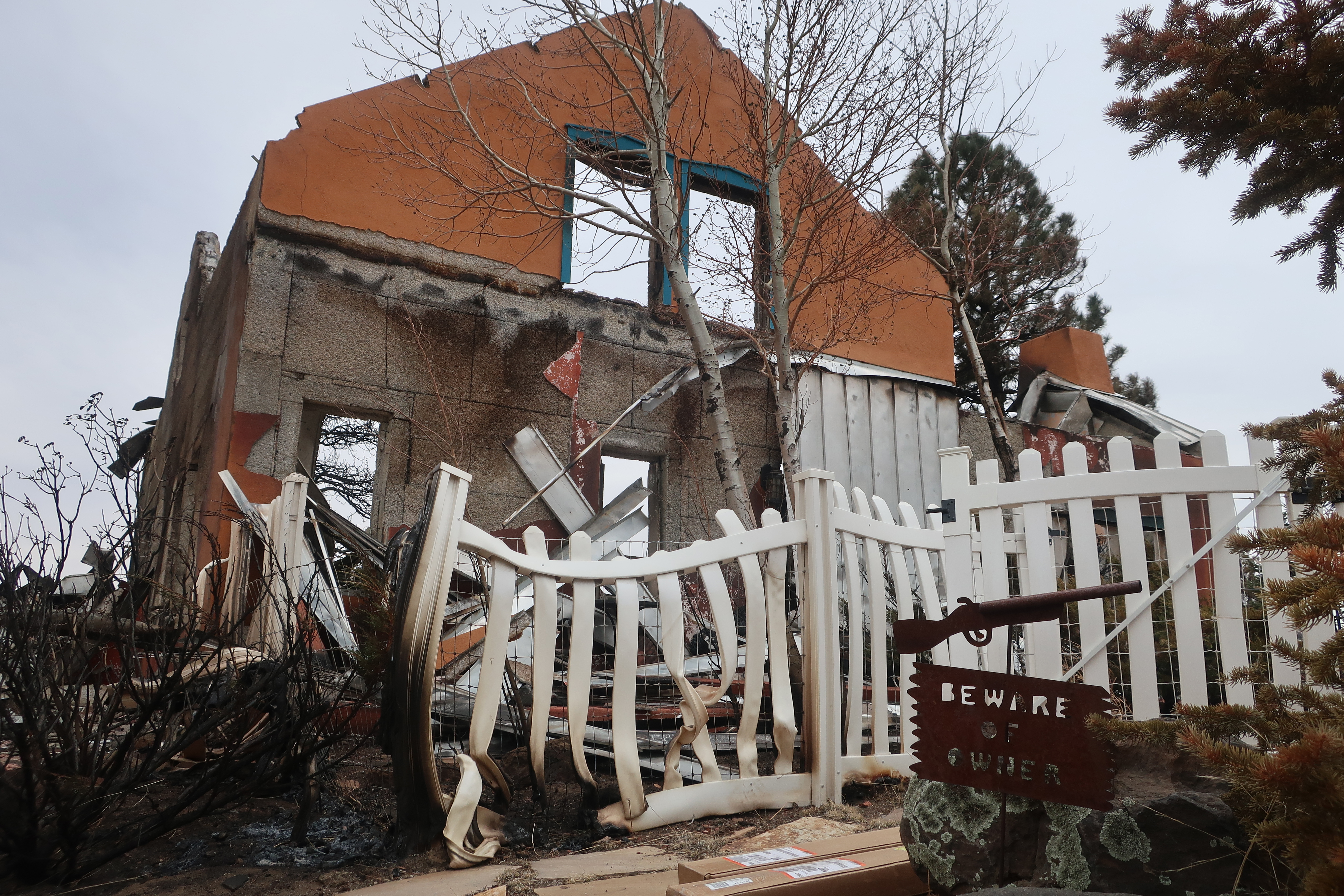 Two packages sit in the driveway of the home that Jeanne and Mike Welnick owned outside Flagstaff, Ariz., on Tuesday. A massive wildfire that started Easter Sunday burned about 30 square miles and more than a dozen homes, hopscotching across the parched landscape. 