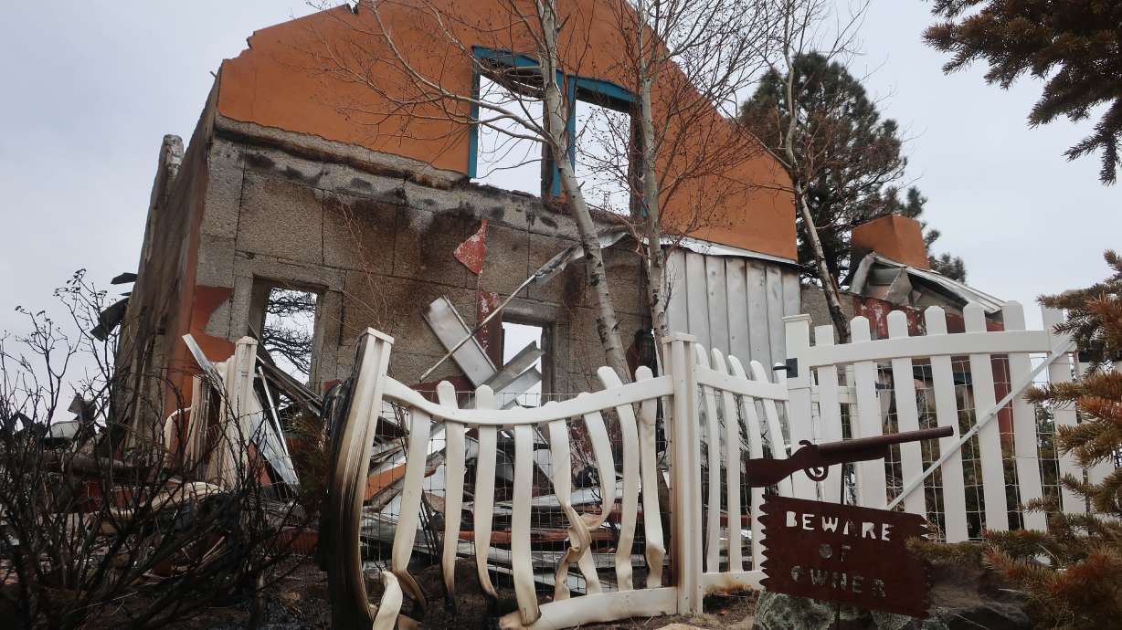 Two packages sit in the driveway of the home that Jeanne and Mike Welnick owned outside Flagstaff, Ariz., on Tuesday. A massive wildfire that started Easter Sunday burned about 30 square miles and more than a dozen homes, hopscotching across the parched landscape.