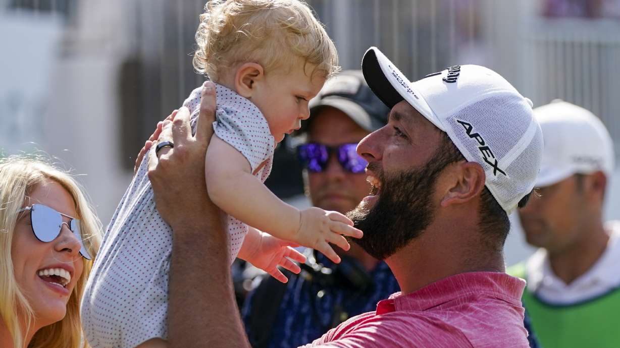 Jon Rahm, of Spain, holds up his son Kepa as he celebrates his victory the Mexico Open at Vidanta, in Puerto Vallarta, Mexico, Sunday, May 1, 2022.