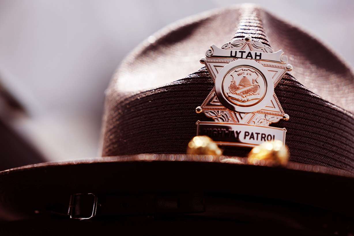 Utah Highway Patrol trooper Brandon Ayer’s hat rests on the dashboard as he works on the computer in his car along I-215 near West Valley City on Monday, April 25. Data from UHP shows a variety of bad driving behaviors have surged.