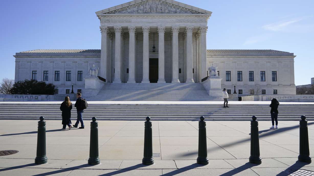 Visitors walk outside the Supreme Court building on Capitol Hill in Washington, Feb. 21. A unanimous Supreme Court announced Monday it has ruled that Boston violated the free speech rights of a conservative activist when it refused his request to fly a Christian flag on a flagpole outside City Hall.