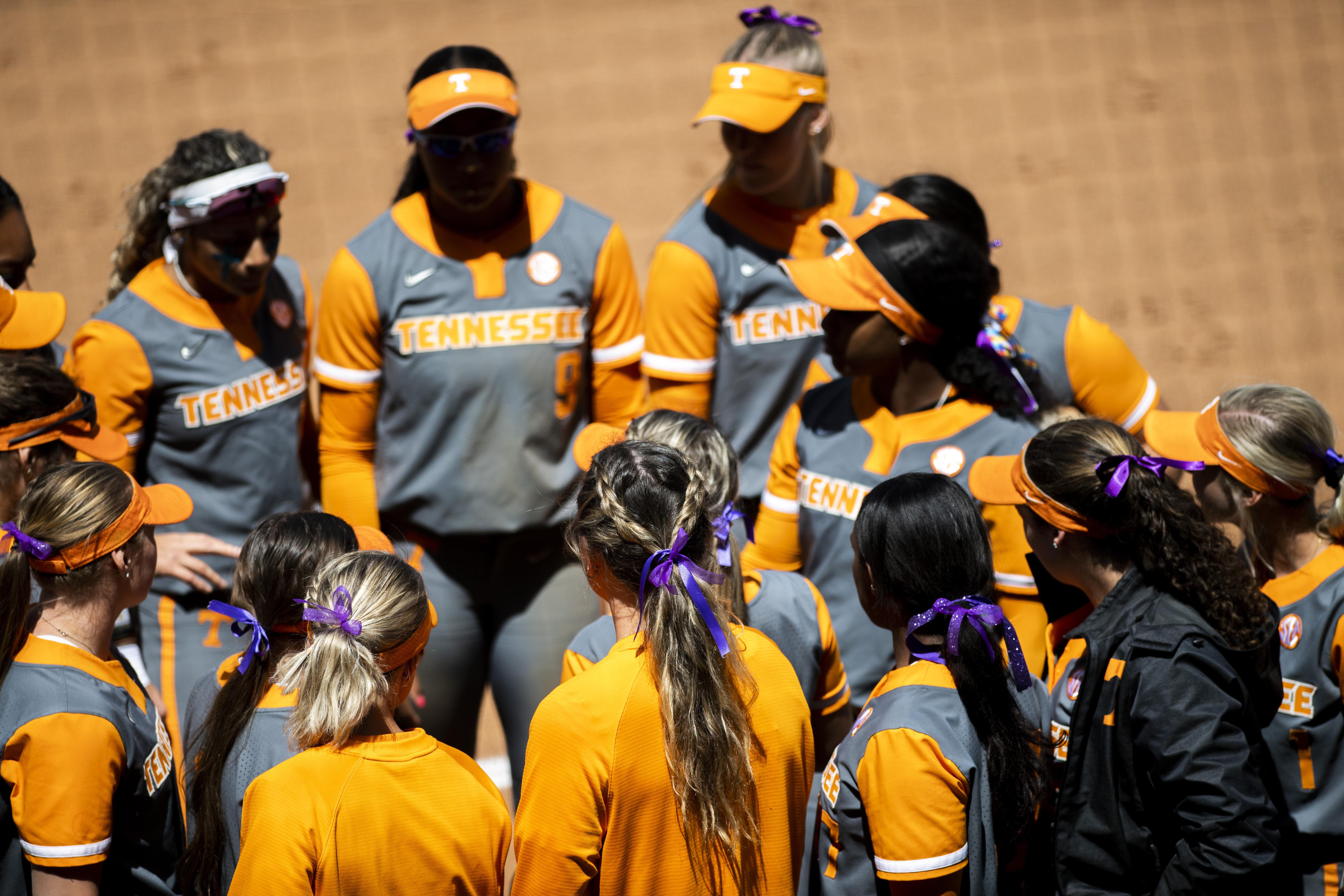 Tennessee softball players wear purple ribbons in their hair during a game against Liberty at Liberty Softball Stadium in Lynchburg, Va. on Wednesday, April 27, 2022 to honor James Madison University softball sophomore catcher Lauren Bernett who recently died. 