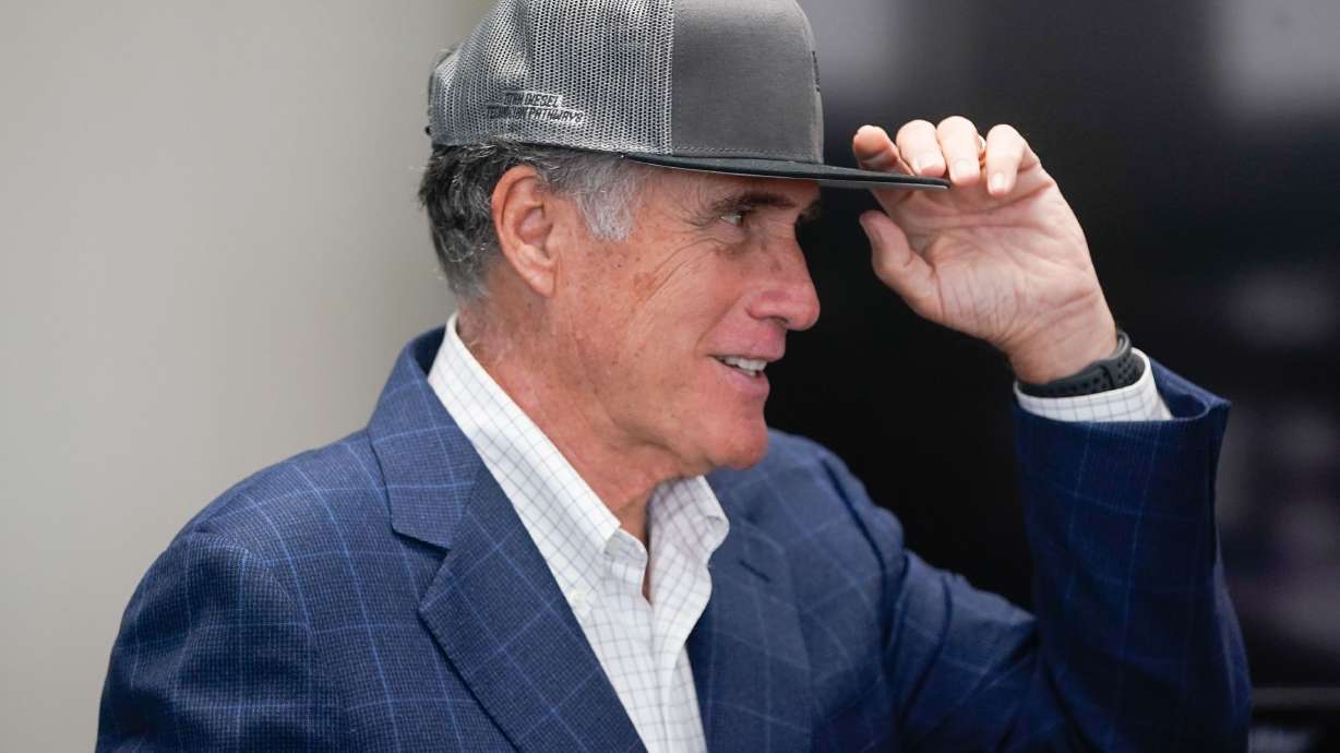 Sen. Mitt Romney, R-Utah, adjusts a hat that he was given after a tour of Kenworth Sales in West Valley City on Nov. 12, 2021. Romney reportedly wears a hat when vacationing in Florida to avoid unwanted attention.