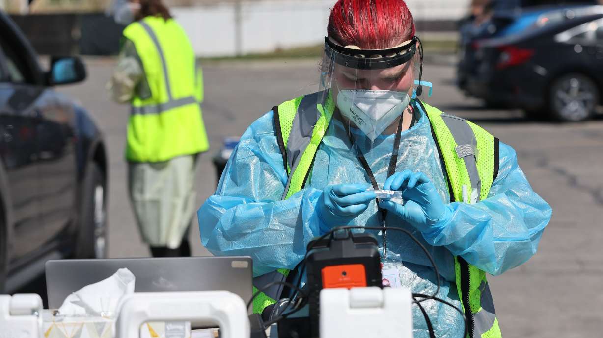 Megan Clay prepares a COVID-19 test in West Valley City on Friday, April 8, 2022. The COVID-19 virus continues to mutate, with a pair of new highly transmissible omicron subvariants sending cases spiking in South Africa.