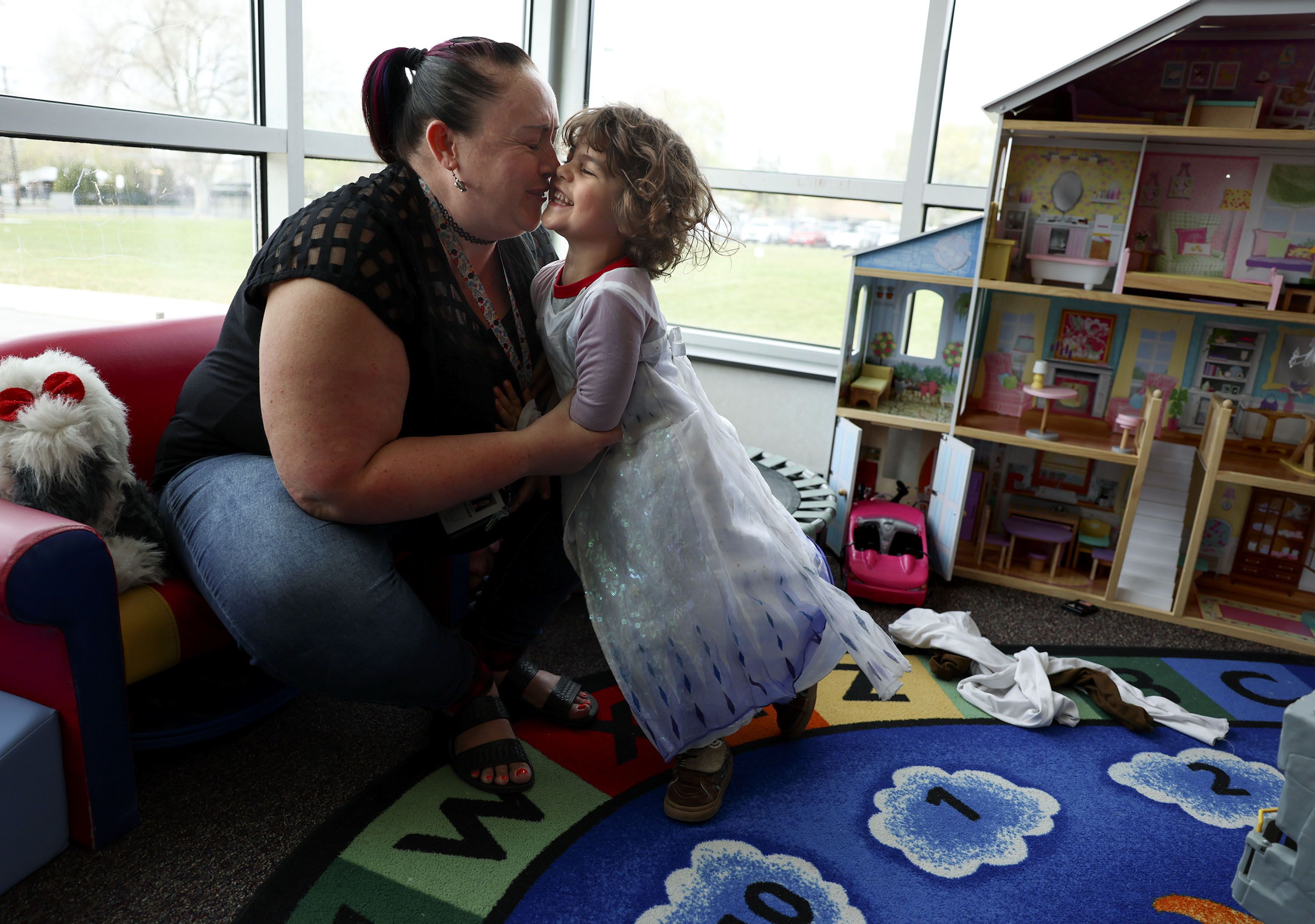 Preschool teacher Kristen Stevenson laughs with 4-year-old Jonah Gonzales, who chose to wear an Elsa dress during playtime, at Sandy Elementary on April 27. Colorado will offer free universal preschool in 2023. What about Utah?
