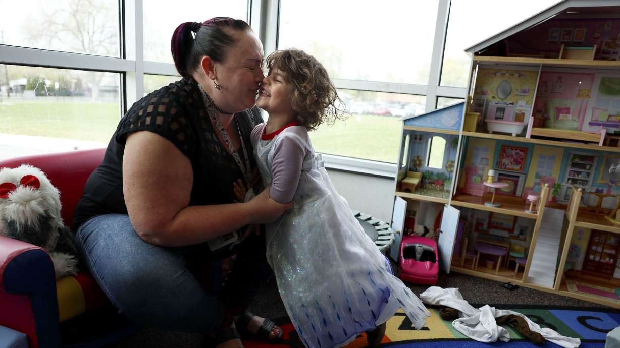 Preschool teacher Kristen Stevenson laughs with 4-year-old Jonah Gonzales, who chose to wear an Elsa dress during playtime, at Sandy Elementary on April 27. Colorado will offer free universal preschool in 2023. What about Utah?