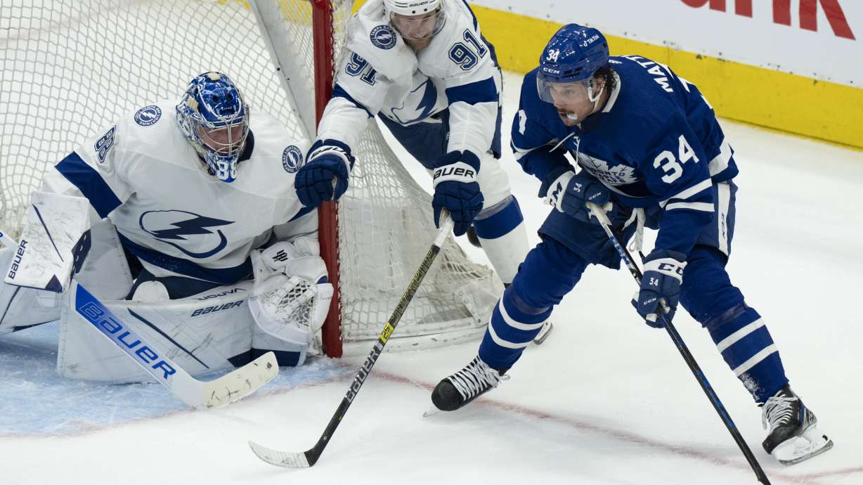 Tampa Bay Lightning center Steven Stamkos (91) and goaltender Andrei Vasilevskiy (88) try to defend against Toronto Maple Leafs center Auston Matthews (34) during the second period of Game 1 of an NHL hockey Stanley Cup first-round playoff series in Toronto, Monday, May 2, 2022.
