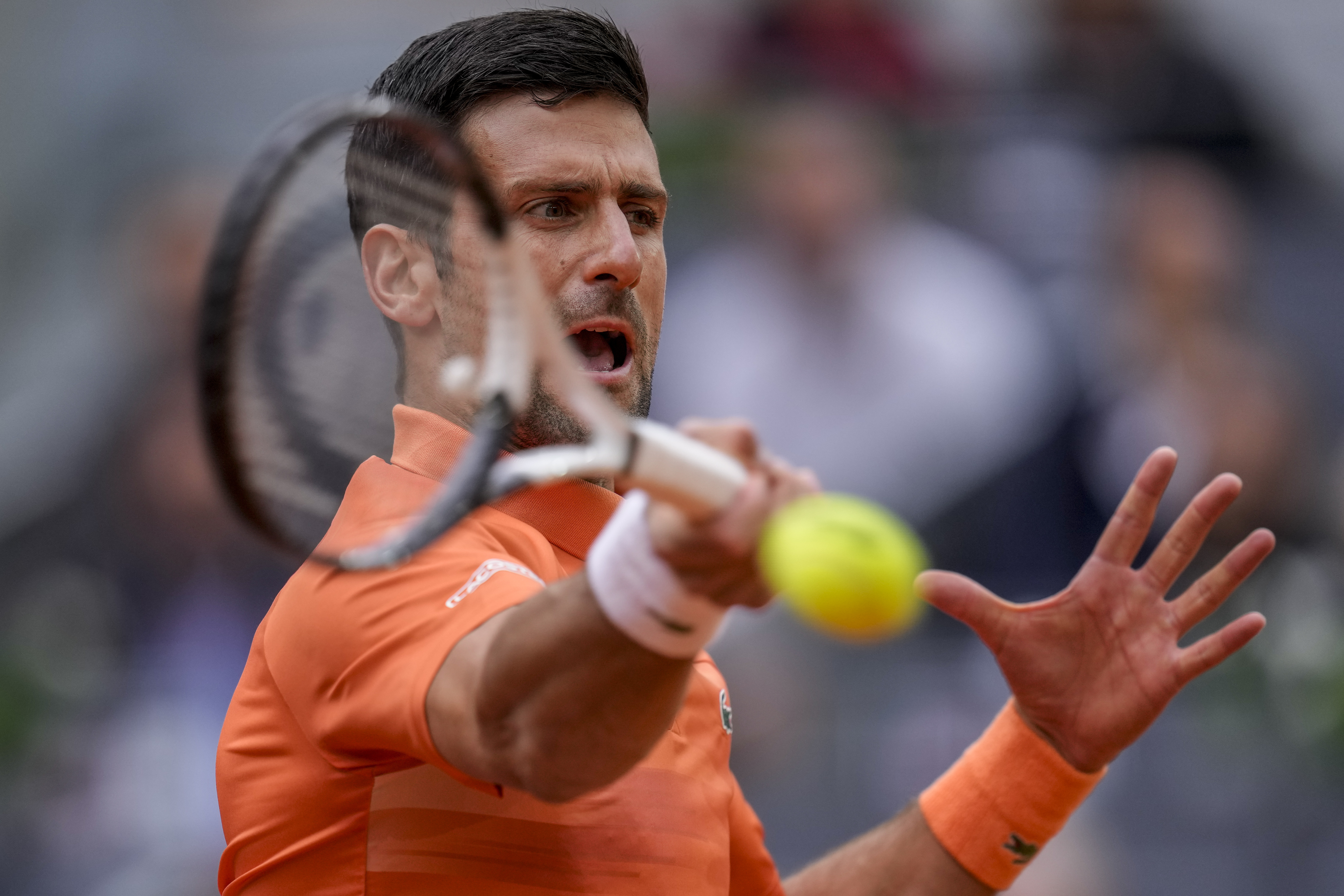 Serbia's Novak Djokovic returns the ball against Gael Monfils, of France, during their match at the Mutua Madrid Open tennis tournament in Madrid, Spain, Tuesday, May 3, 2022.