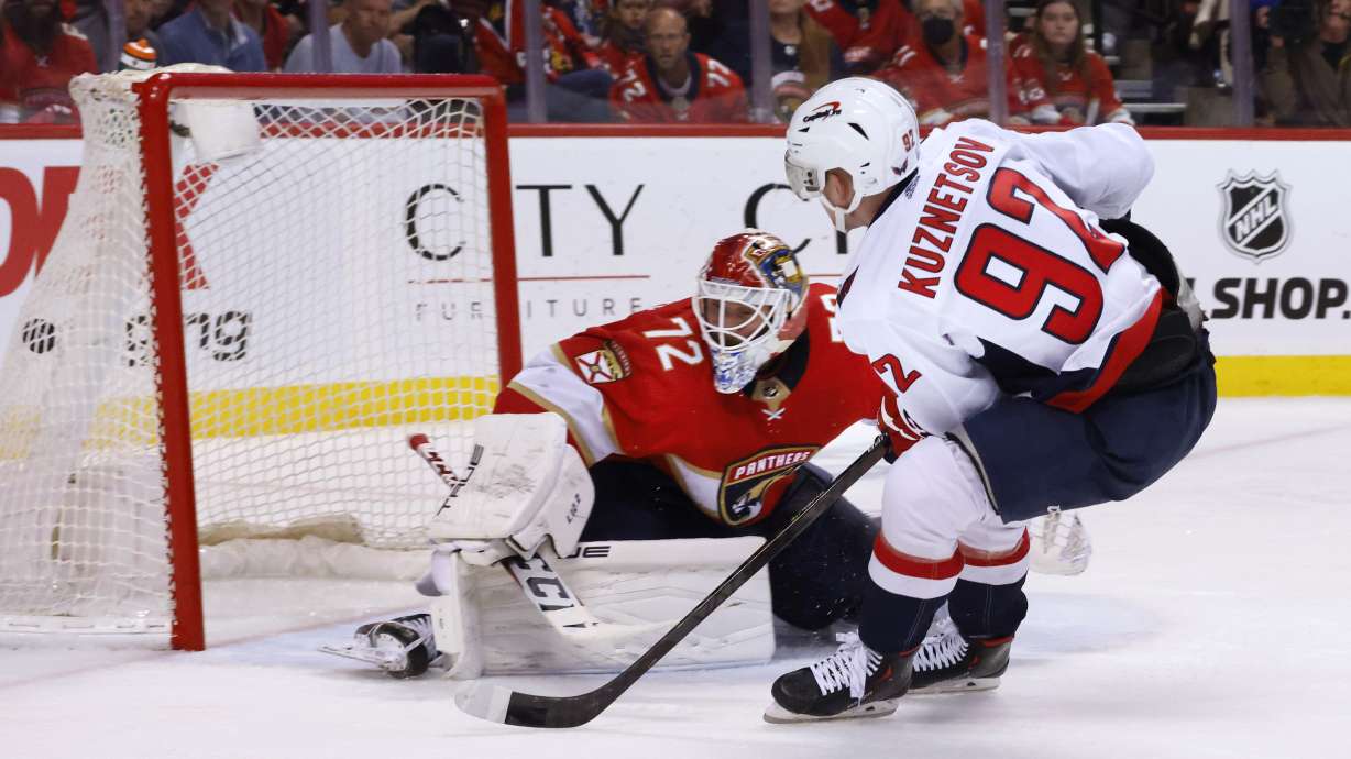 Washington Capitals center Evgeny Kuznetsov (92) scores against Florida Panthers goaltender Sergei Bobrovsky (72) during the third period of Game 1 of an NHL hockey first-round playoff series Tuesday, May 3, 2022, in Sunrise, Fla.