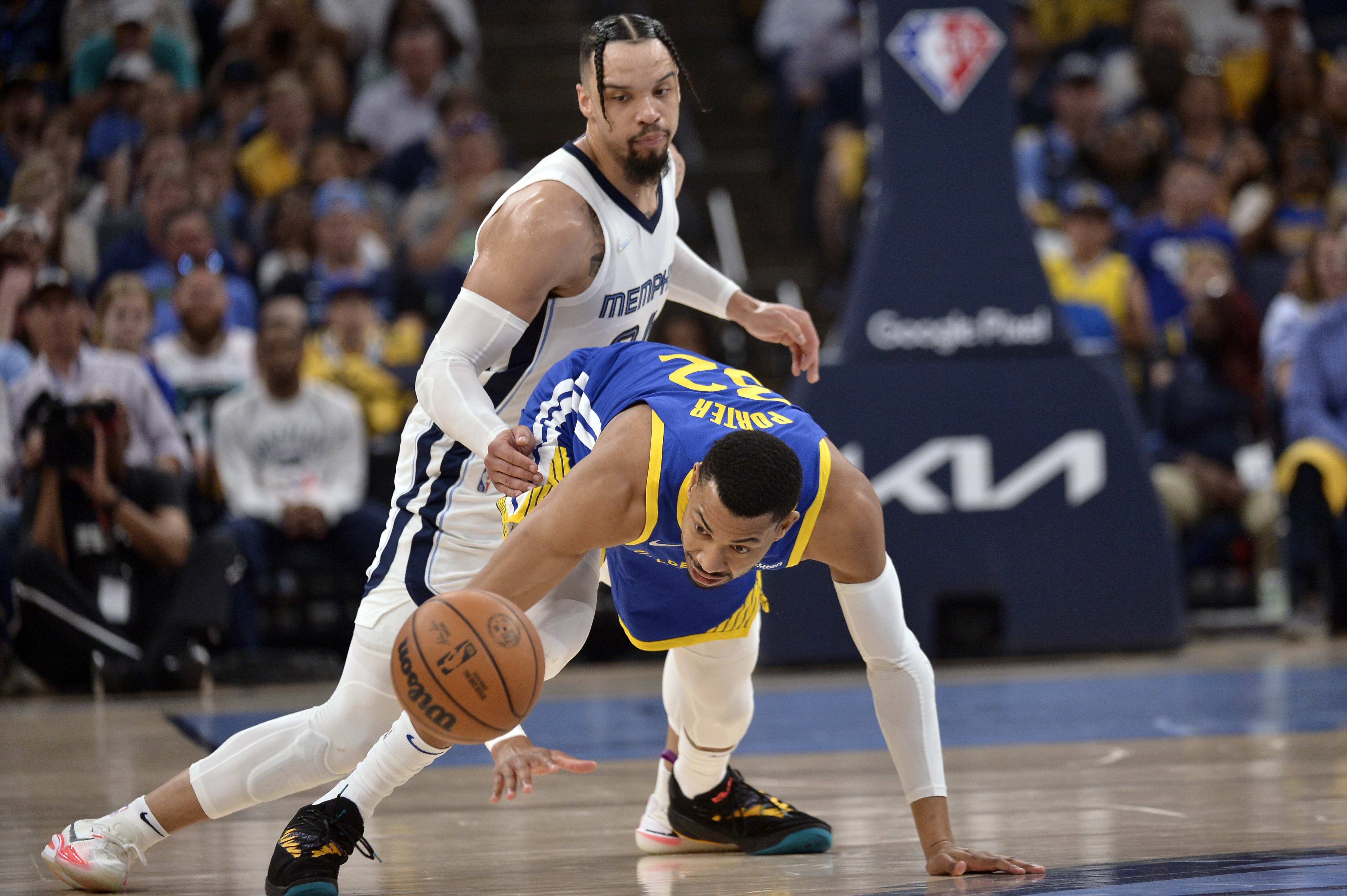 Golden State Warriors forward Otto Porter Jr. (32) and Memphis Grizzlies forward Dillon Brooks, top, struggle for control of the ball during Game 1 of a second-round NBA basketball playoff series Sunday, May 1, 2022, in Memphis, Tenn. 