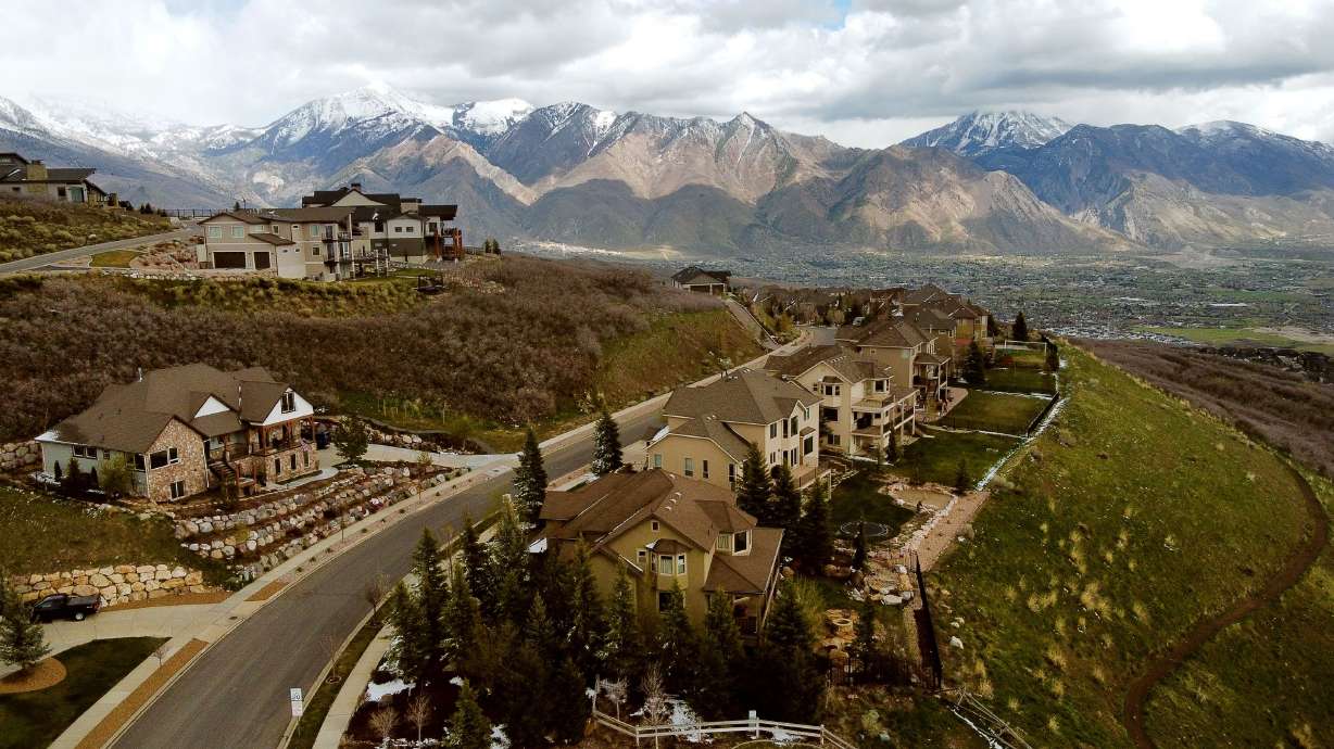Homes atop Traverse Ridge in Draper are pictured with the Alpine area in the background on Tuesday. Even as economists say the nation’s housing market is overvalued in terms we’ve never seen before, they’re not predicting a nationwide crash or market correction.