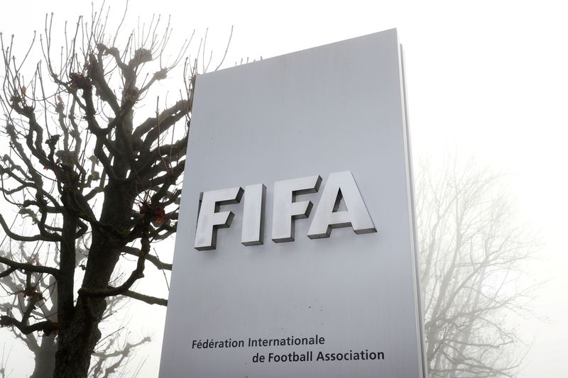 FILE PHOTO: FIFA's logo is seen in front of its headquarters during a foggy autumn day in Zurich, Switzerland November 18, 2020.