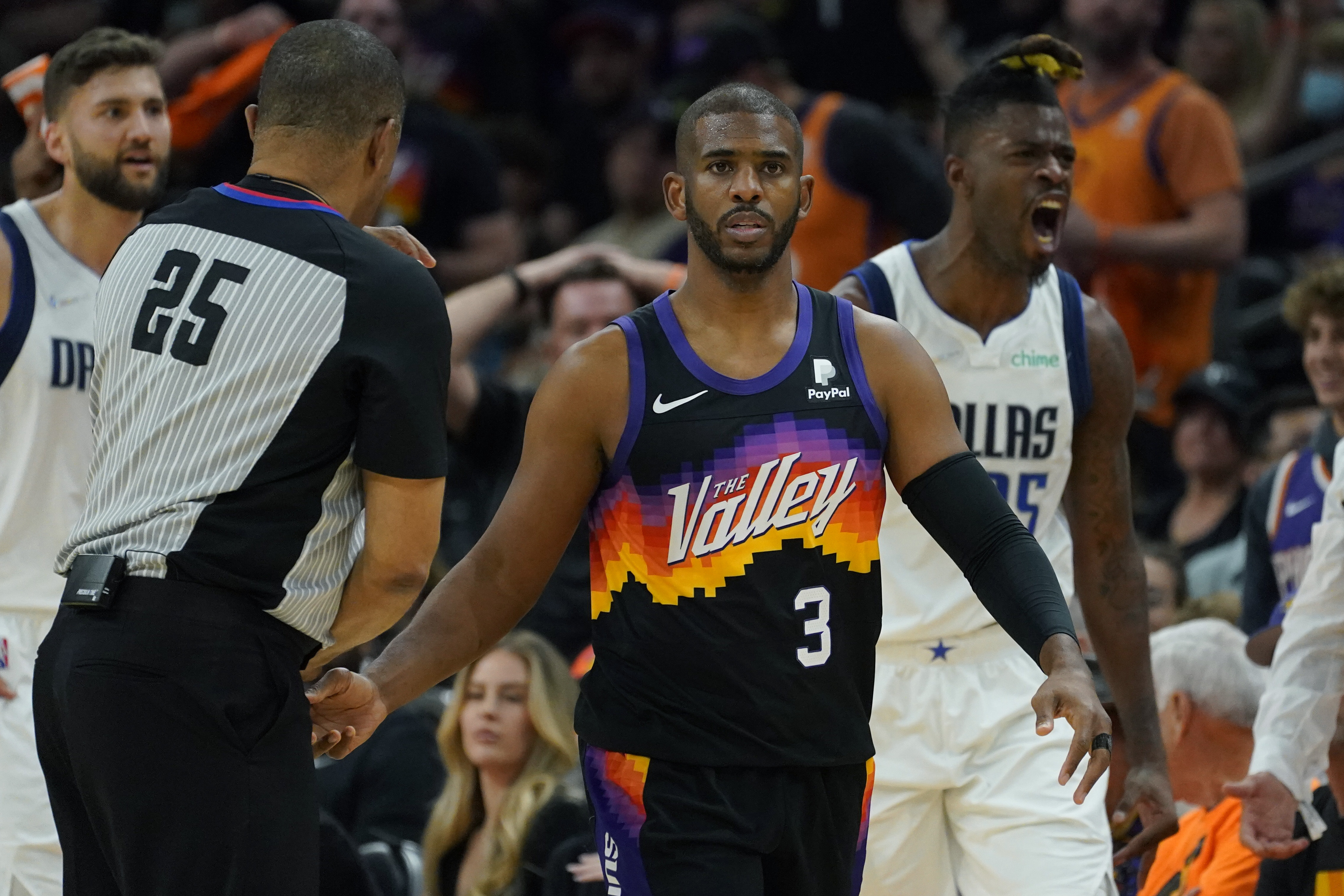 Phoenix Suns guard Chris Paul (3) and Dallas Mavericks forward Reggie Bullock, right, react after Paul was called for a foul during the first half of Game 2 of an NBA basketball second round playoff series, Wednesday, May 4, 2022, in Phoenix. 