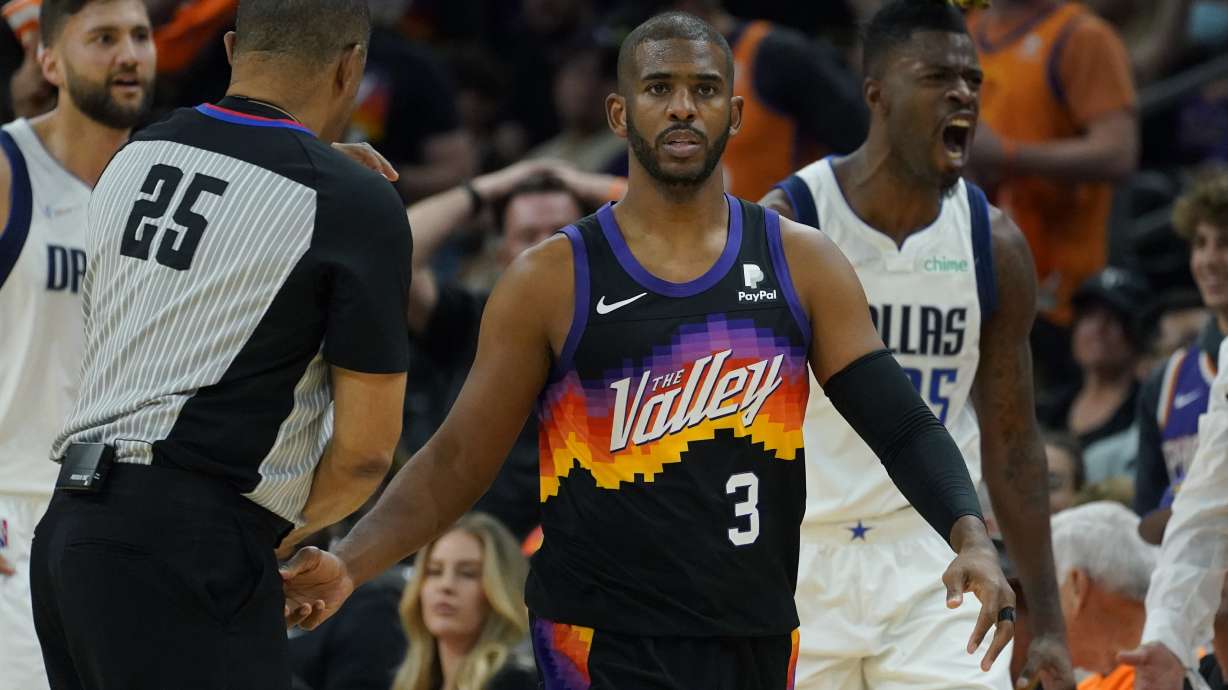 Phoenix Suns guard Chris Paul (3) and Dallas Mavericks forward Reggie Bullock, right, react after Paul was called for a foul during the first half of Game 2 of an NBA basketball second round playoff series, Wednesday, May 4, 2022, in Phoenix.
