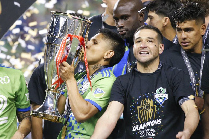 May 4, 2022; Seattle, WA, USA; Seattle Sounders FC forward Raúl Ruidíaz (9) kisses the Concacaf Champions League trophy following a 3-0 second leg victory against Pumas at Lumen Field.
