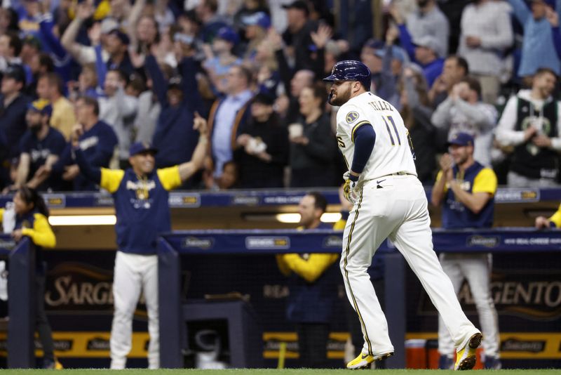 May 4, 2022; Milwaukee, Wisconsin, USA;  Milwaukee Brewers first baseman Rowdy Tellez (11) rounds the bases after hitting a grand slam home run during the third inning against the Cincinnati Reds at American Family Field.