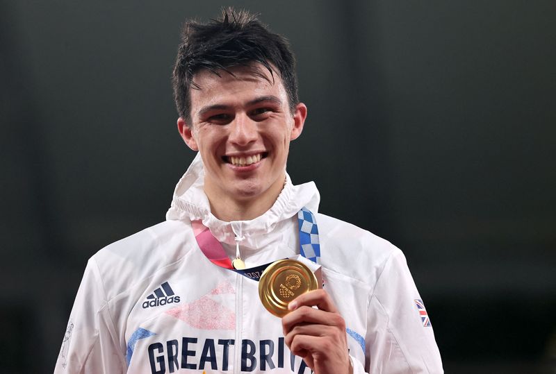 FILE PHOTO: Tokyo 2020 Olympics - Modern Pentathlon - Men's Individual - Medal Ceremony - Tokyo Stadium - Tokyo, Japan - August 7, 2021. Gold medalist, Joseph Choong of Britain, celebrates on the podium