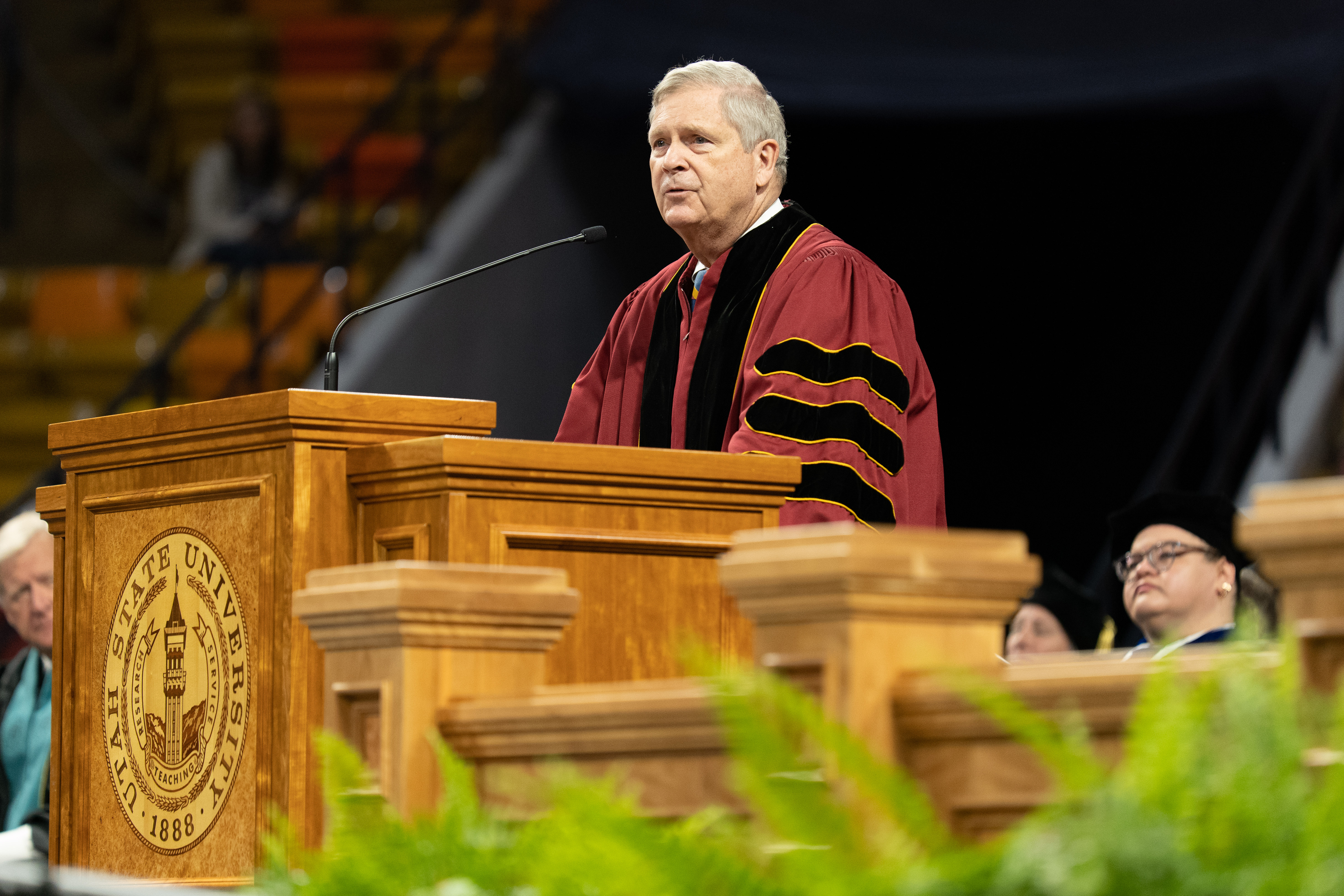 U.S. Secretary of Agriculture Thomas J. Vilsack addresses the crowd of graduates at the Dee Glen Smith Spectrum during Utah State University's commencement ceremony Thursday.