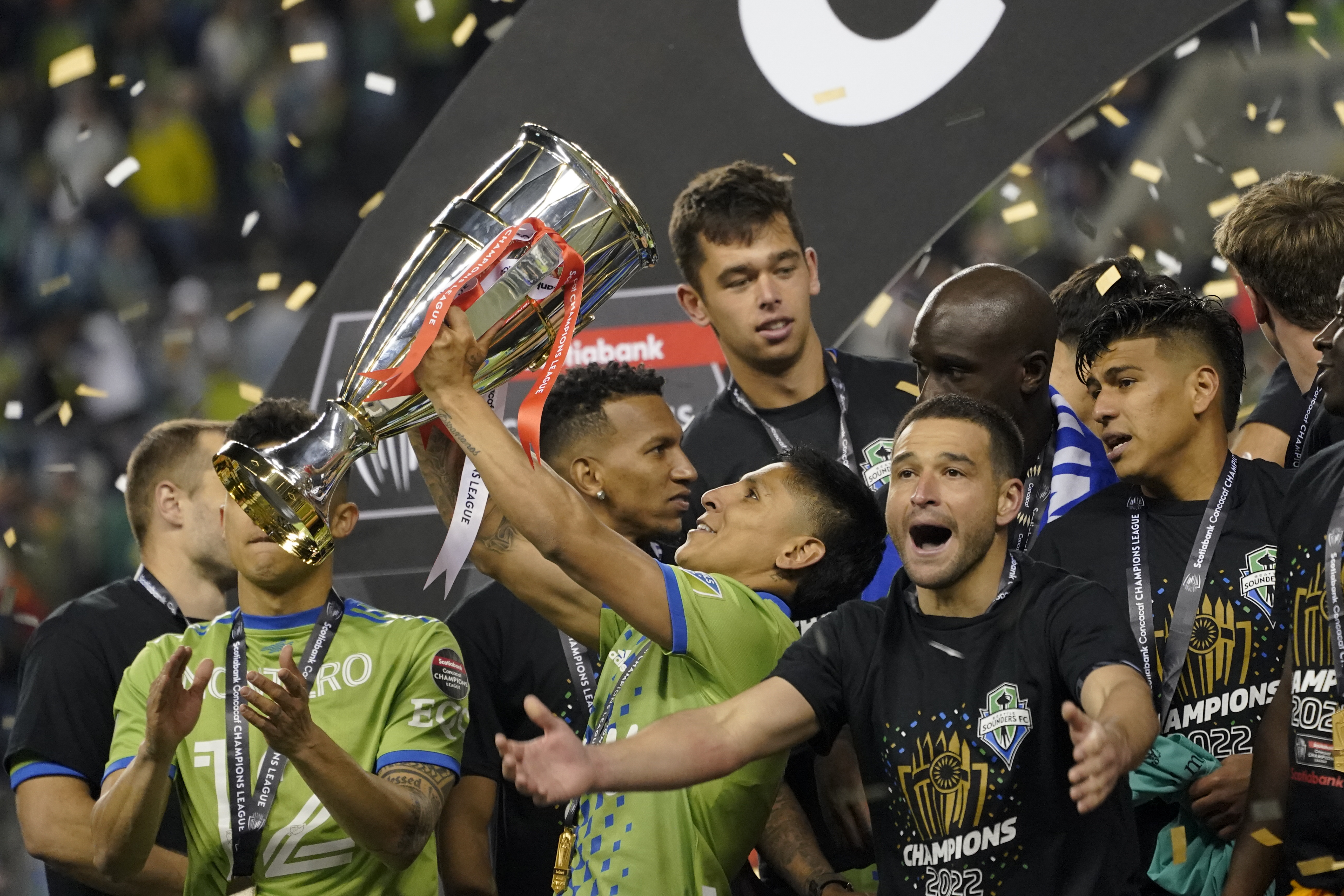 United States' Seattle Sounders forward Raul Ruidiaz holds the trophy alongside teammate midfielder Nicolás Lodeiro after the Sounders defeated Mexico's Pumas to win the CONCACAF Champions League soccer final Wednesday, May 4, 2022, in Seattle. 