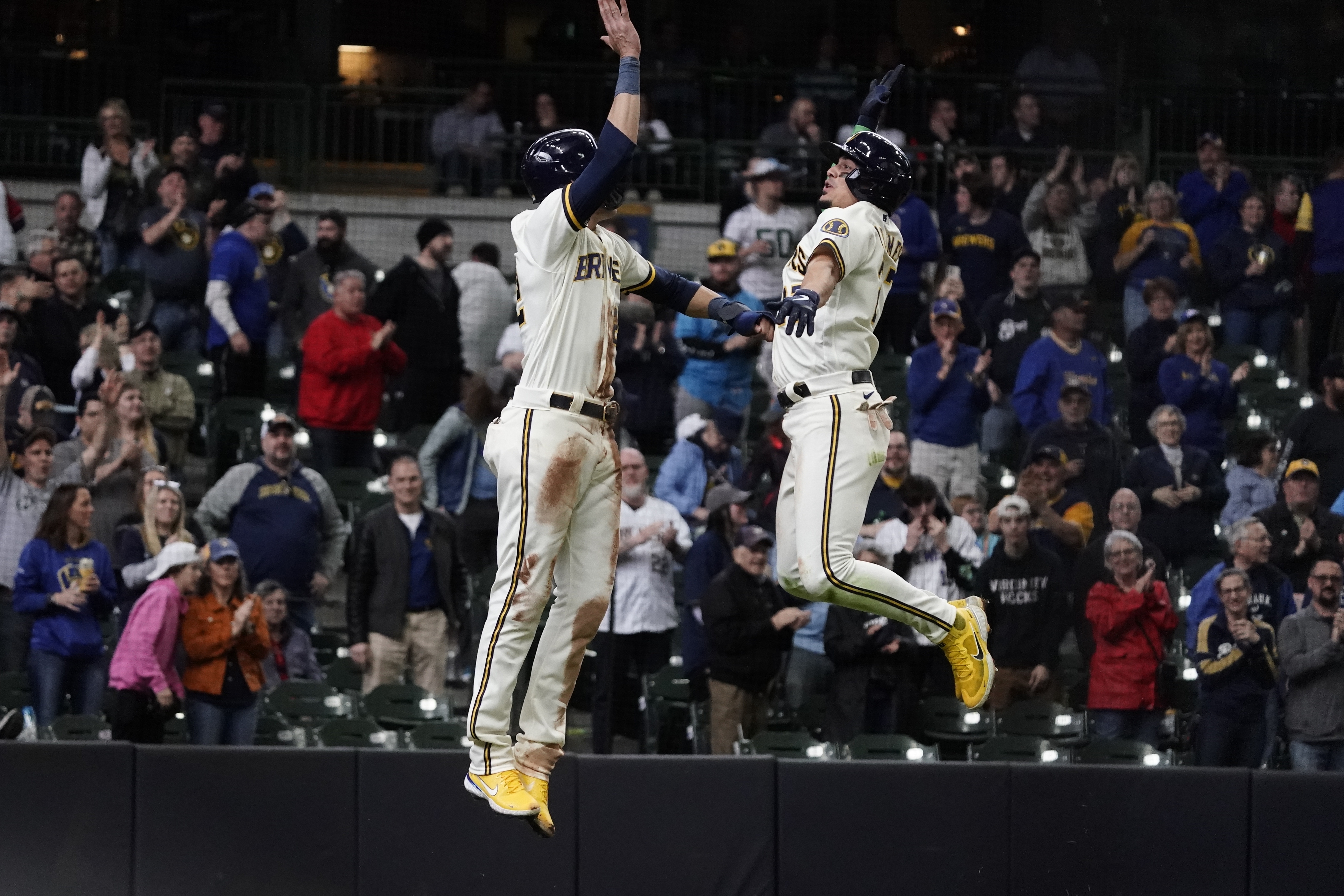 Milwaukee Brewers' Willy Adames celebrates with Christian Yelich after hitting a two-run home run during the eighth inning of a baseball game against the Cincinnati Reds Thursday, May 5, 2022, in Milwaukee. 