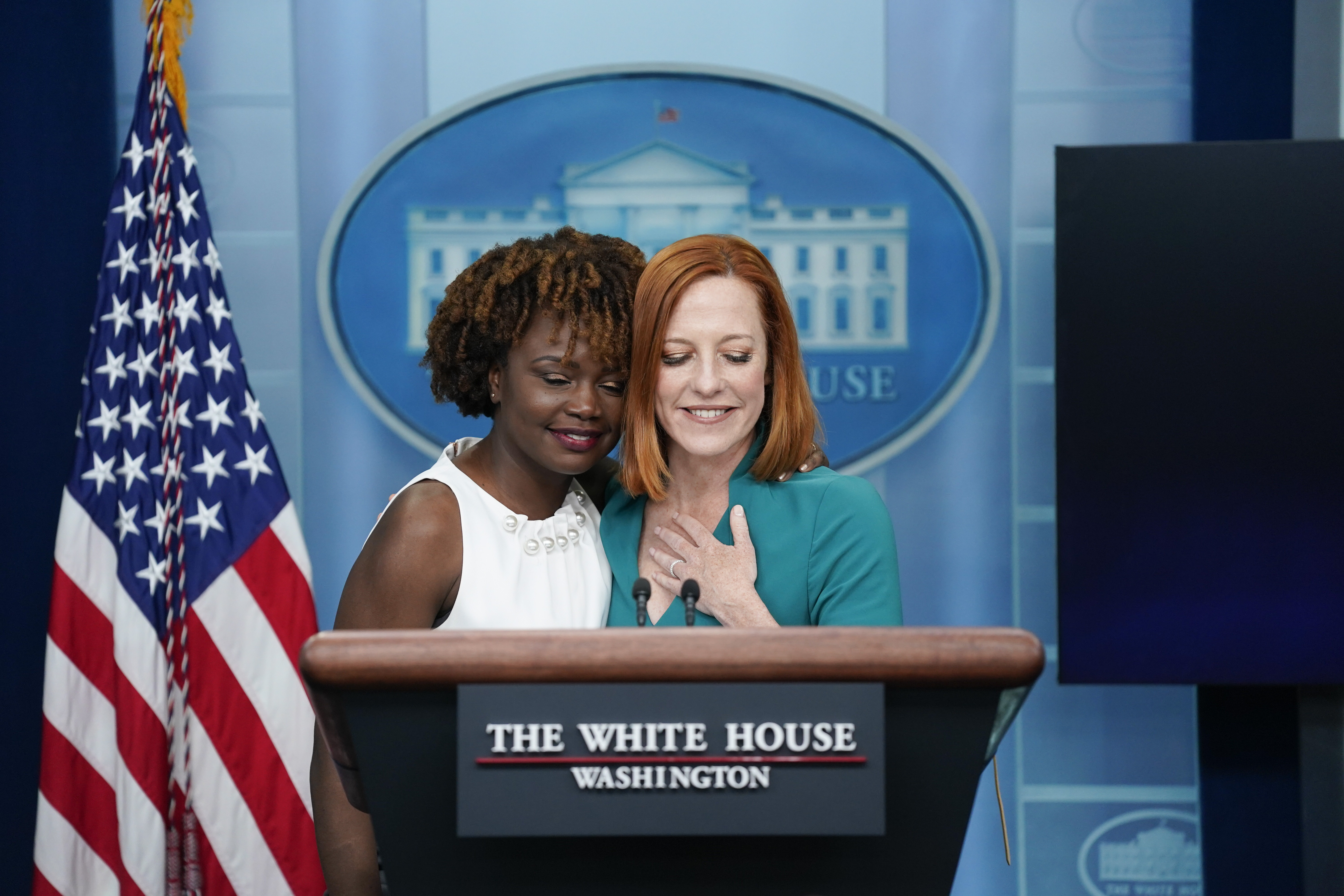 White House press secretary Jen Psaki hugs incoming press secretary Karine Jean-Pierre during a press briefing at the White House, Thursday, in Washington.