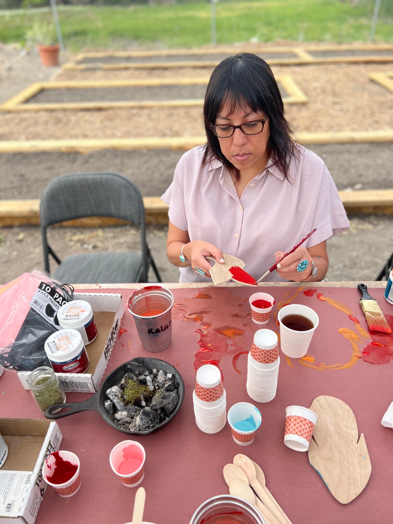 Kristina Groves of the Urban Indian Center of Salt Lake paints a flower to be placed on a mural on April 30. The mural was featured at a community event honoring missing and murdered indigenous relatives on Thursday.