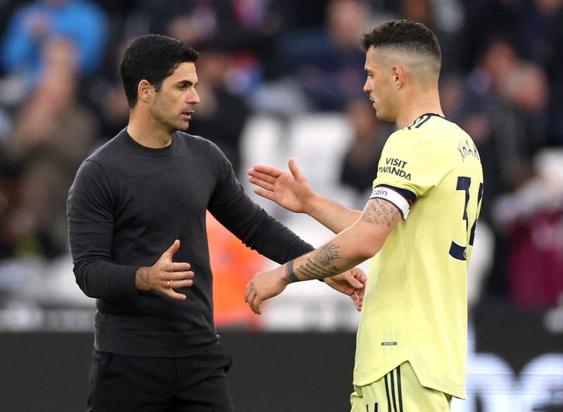 FILE PHOTO: Soccer Football - Premier League - West Ham United v Arsenal - London Stadium, London, Britain - May 1, 2022 Arsenal manager Mikel Arteta and Granit Xhaka celebrate after the match Action Images via Reuters/Matthew Childs
