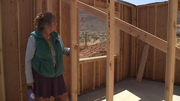 Janis Adkins stands in what will be her side of a new duplex in Moab. She is getting the home through the nonprofit Community Rebuilds, which focuses on giving low-income Moab residents an opportunity to become homeowners through a self-help program.